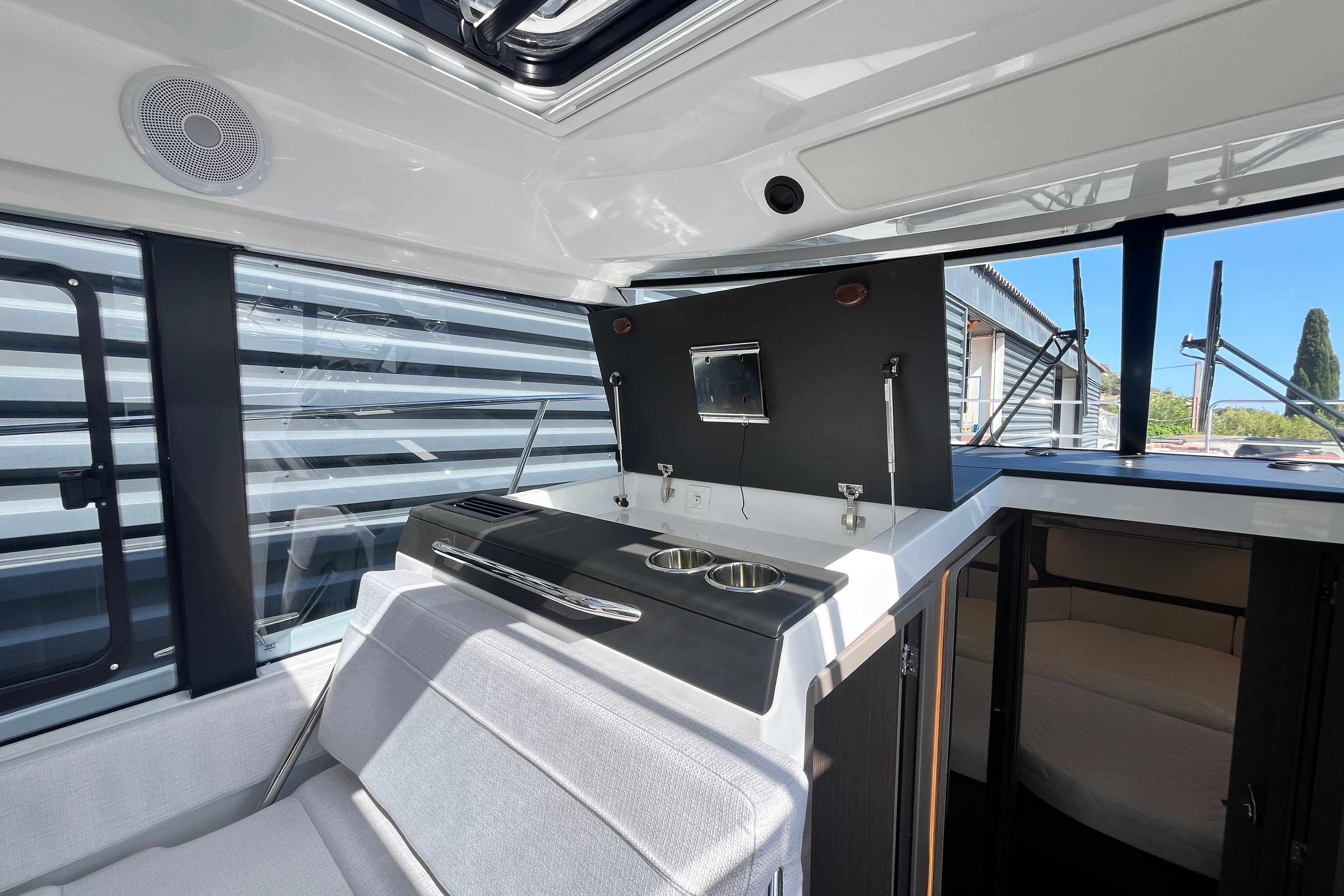 Interior of 2026 Jeanneau Merry Fisher 1095, featuring modern kitchen and seating area.
