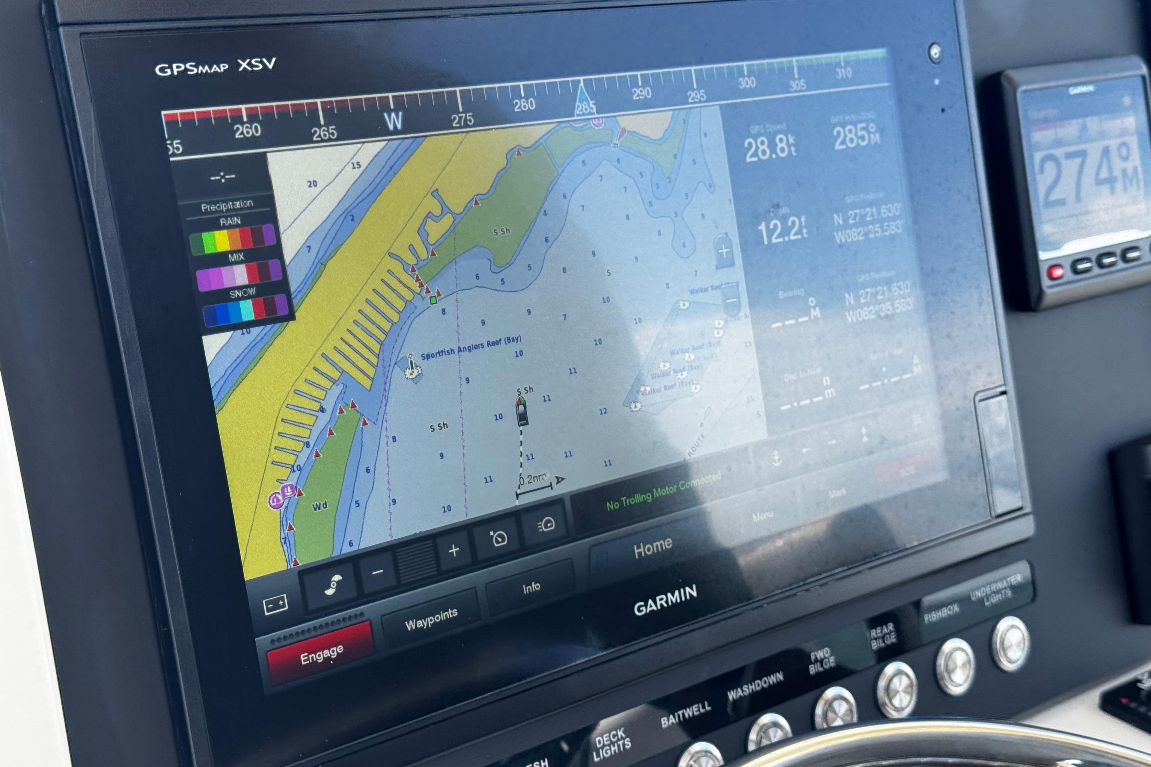 Garmin GPS display on 2015 Sailfish 320 CC boat, showing navigation and weather data.