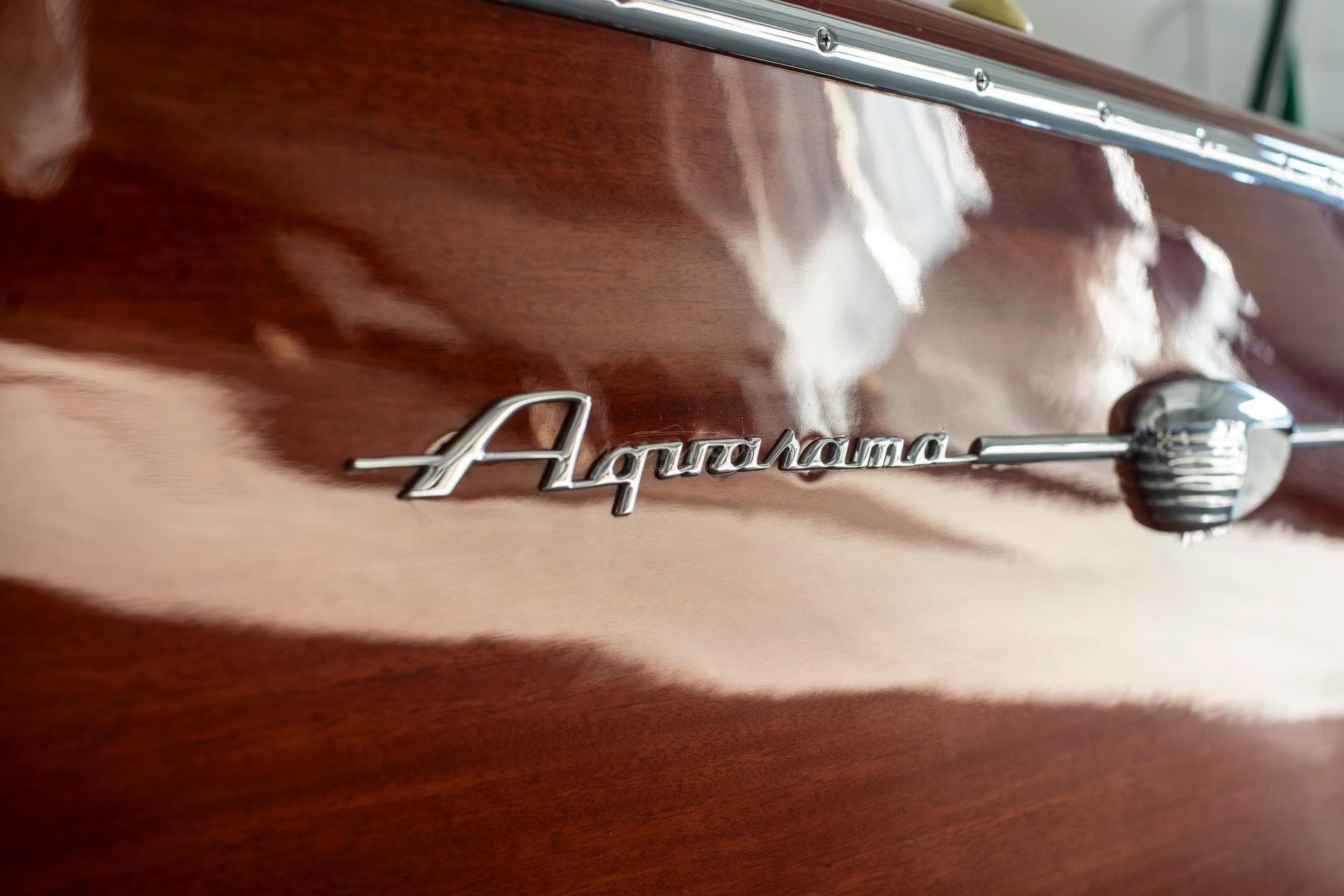 1967 Riva Aquarama boat emblem on polished wooden surface.