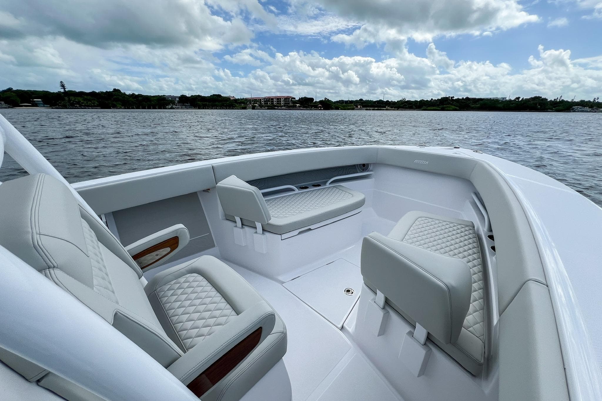 2026 Jupiter 30 boat interior with luxurious seating on a calm water backdrop.