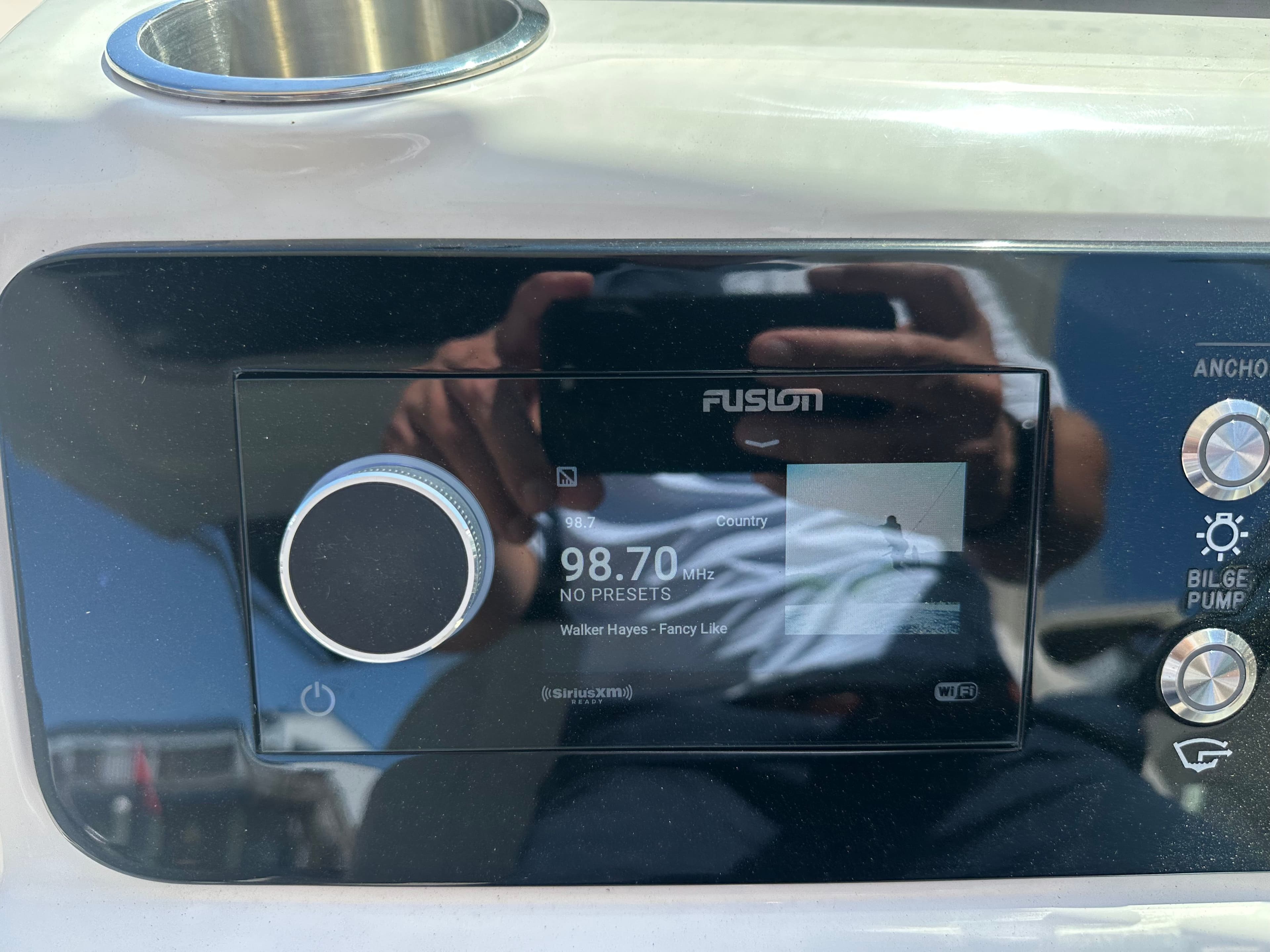 Fusion radio on Sea Ray SLX 310 Outboard 2023, displaying 98.7 MHz.