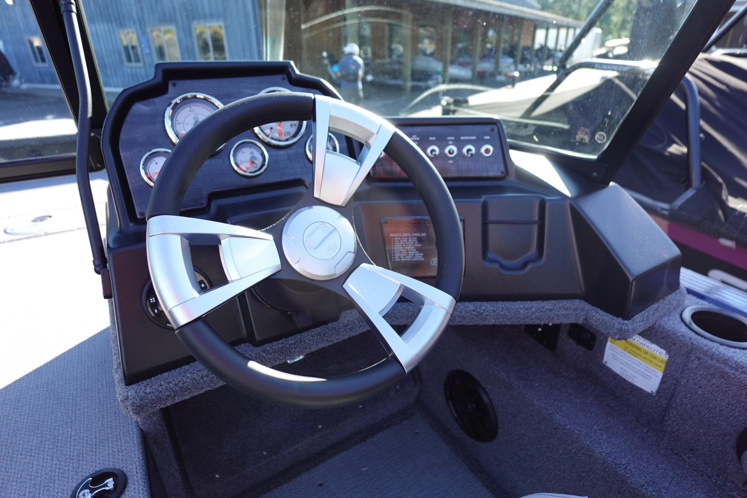Steering wheel and dashboard of 2025 G3 AV19SF boat, featuring modern gauges and controls.