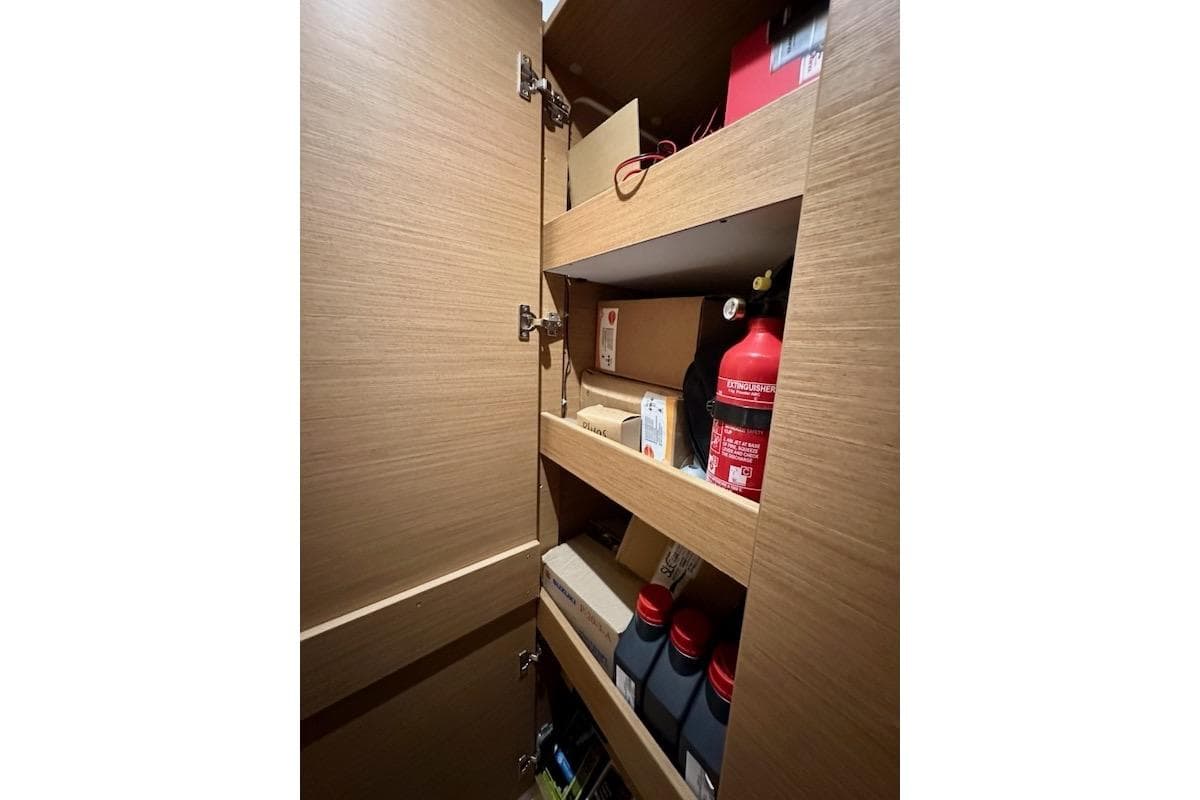 Storage cabinet with fire extinguisher and supplies on shelves, Excess 14, 2025 model.