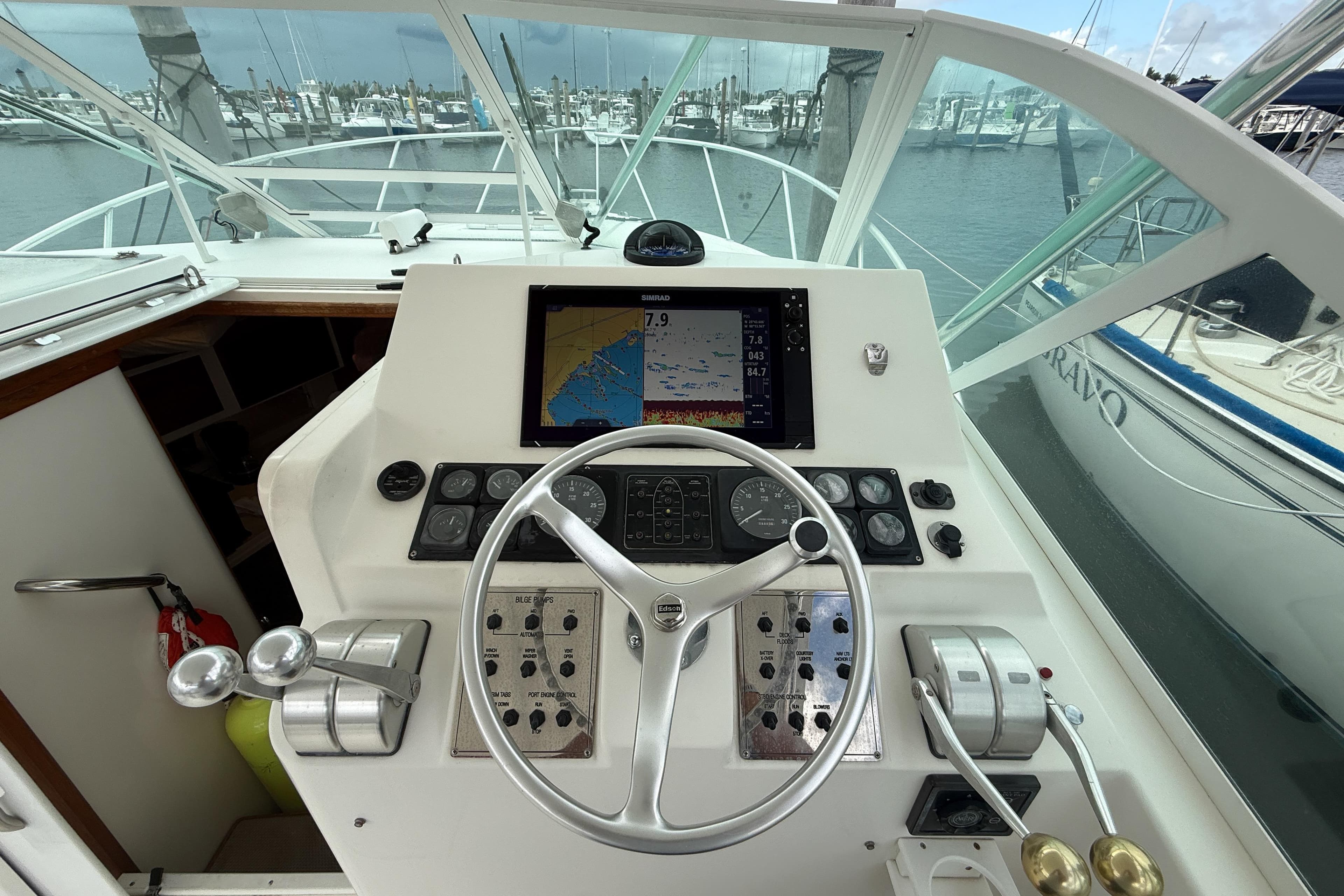 Helm of 1998 Cabo 31 Express boat with navigation equipment and steering wheel.