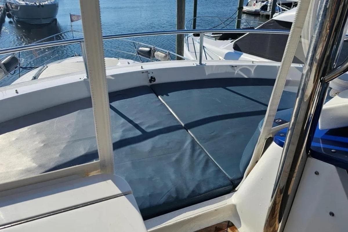 2005 Neptunus 56 Flybridge yacht with sun deck, docked at marina.