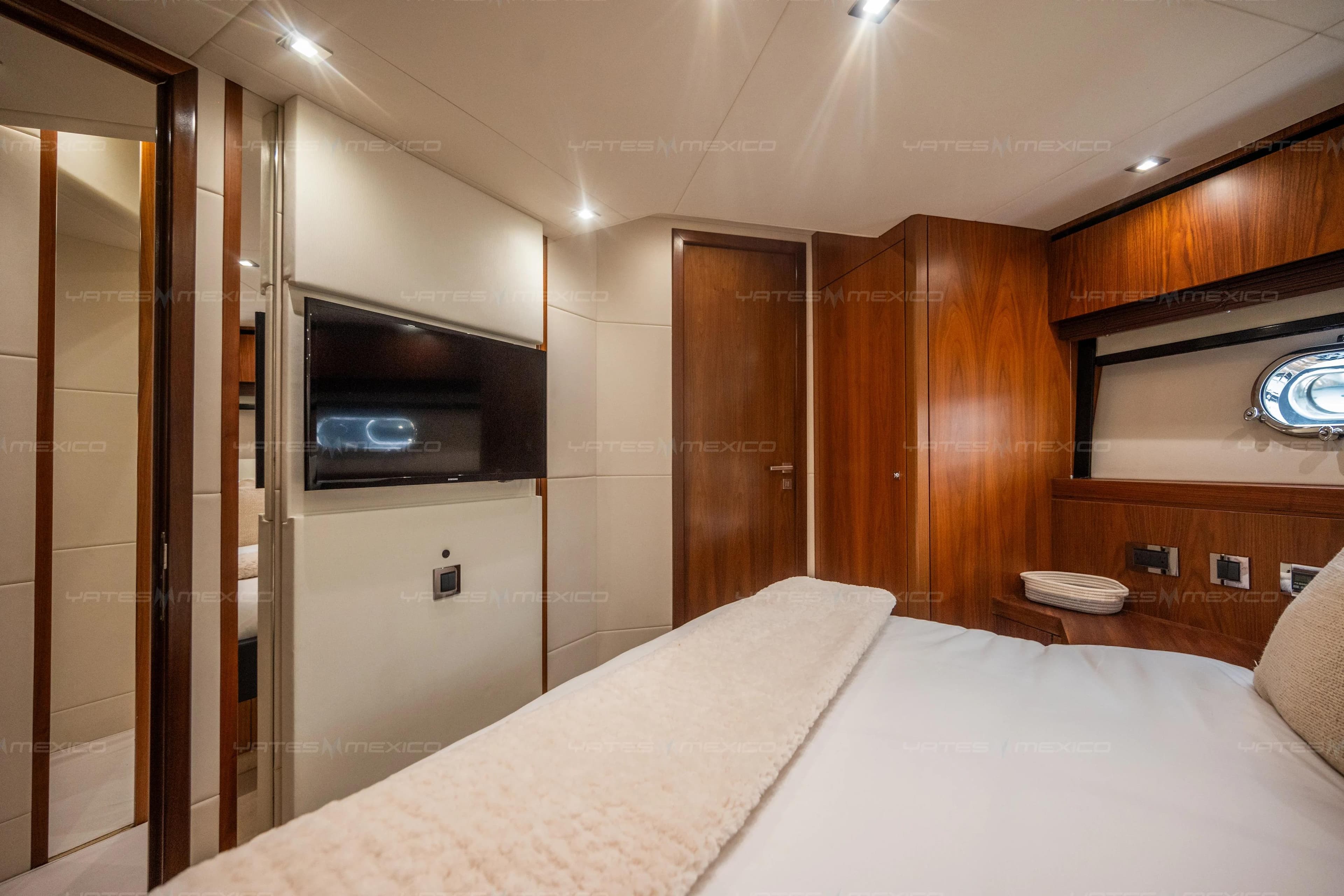 Luxurious cabin interior of 2015 Sunseeker 75 Yacht with wood paneling and modern amenities.