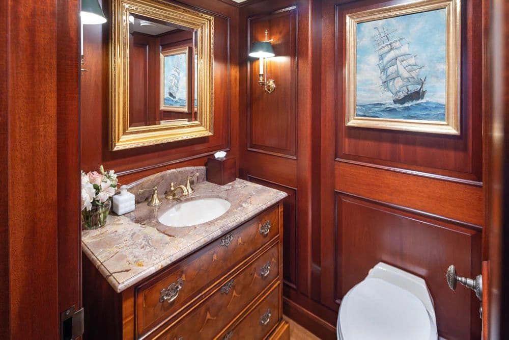Luxurious bathroom on Delta Marine Flybridge Motoryacht, 1989, with wood paneling and artwork.