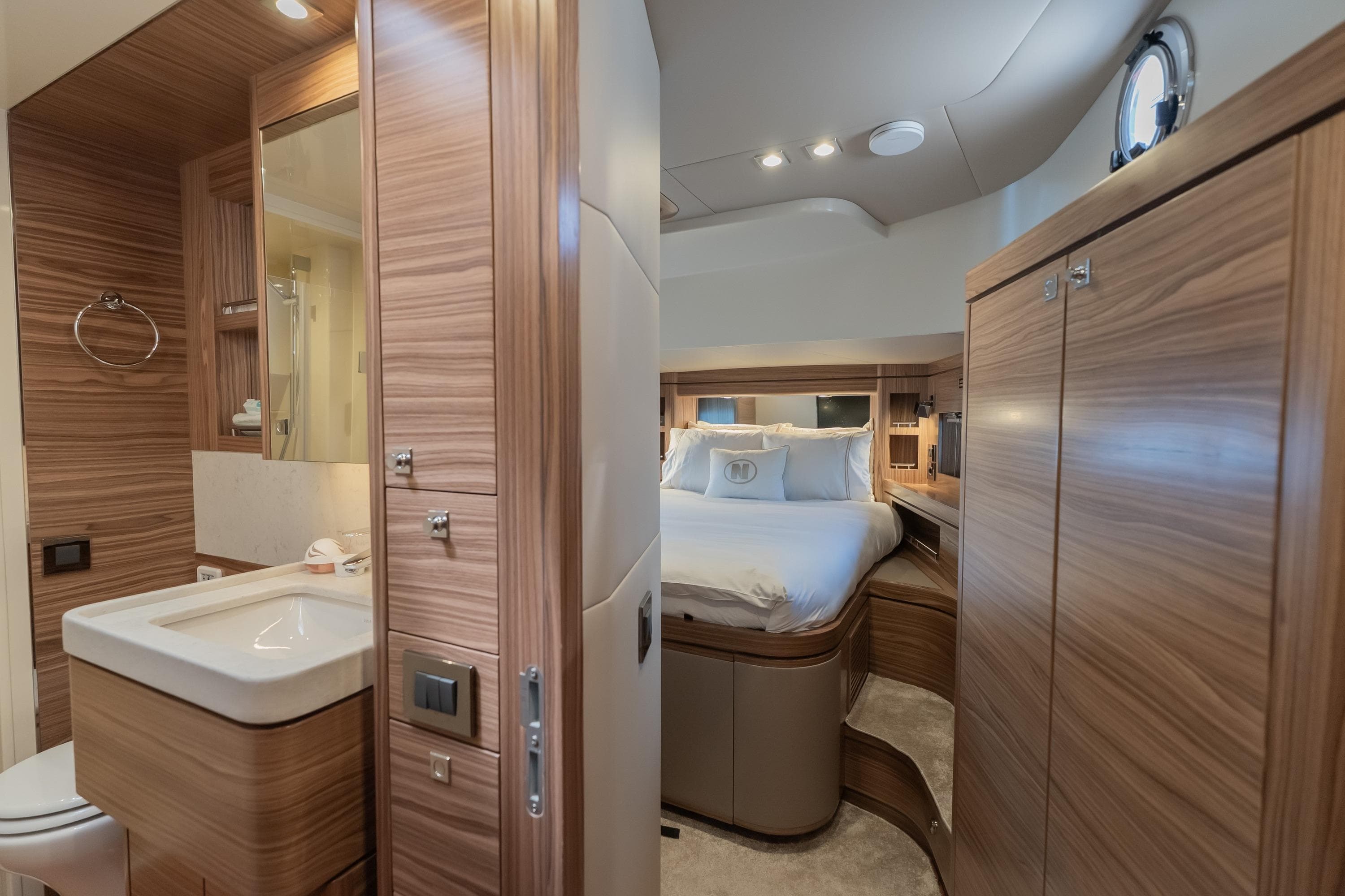 Luxurious 2024 Nordhavn 51 yacht interior with elegant wood finishes and cozy bedroom.