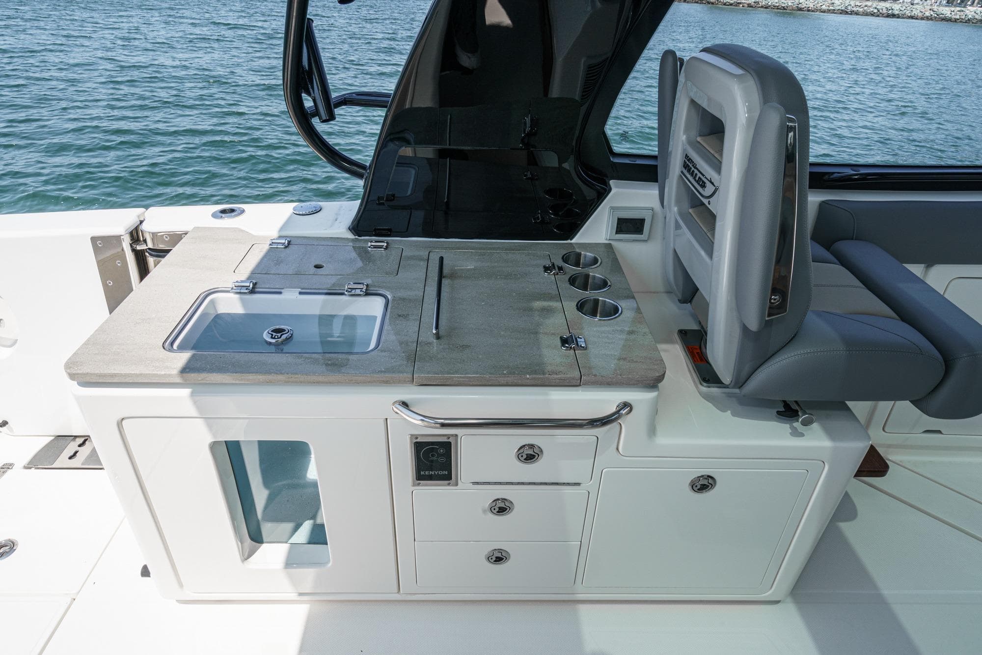 2024 Boston Whaler 380 Realm boat interior with kitchenette and seating area.