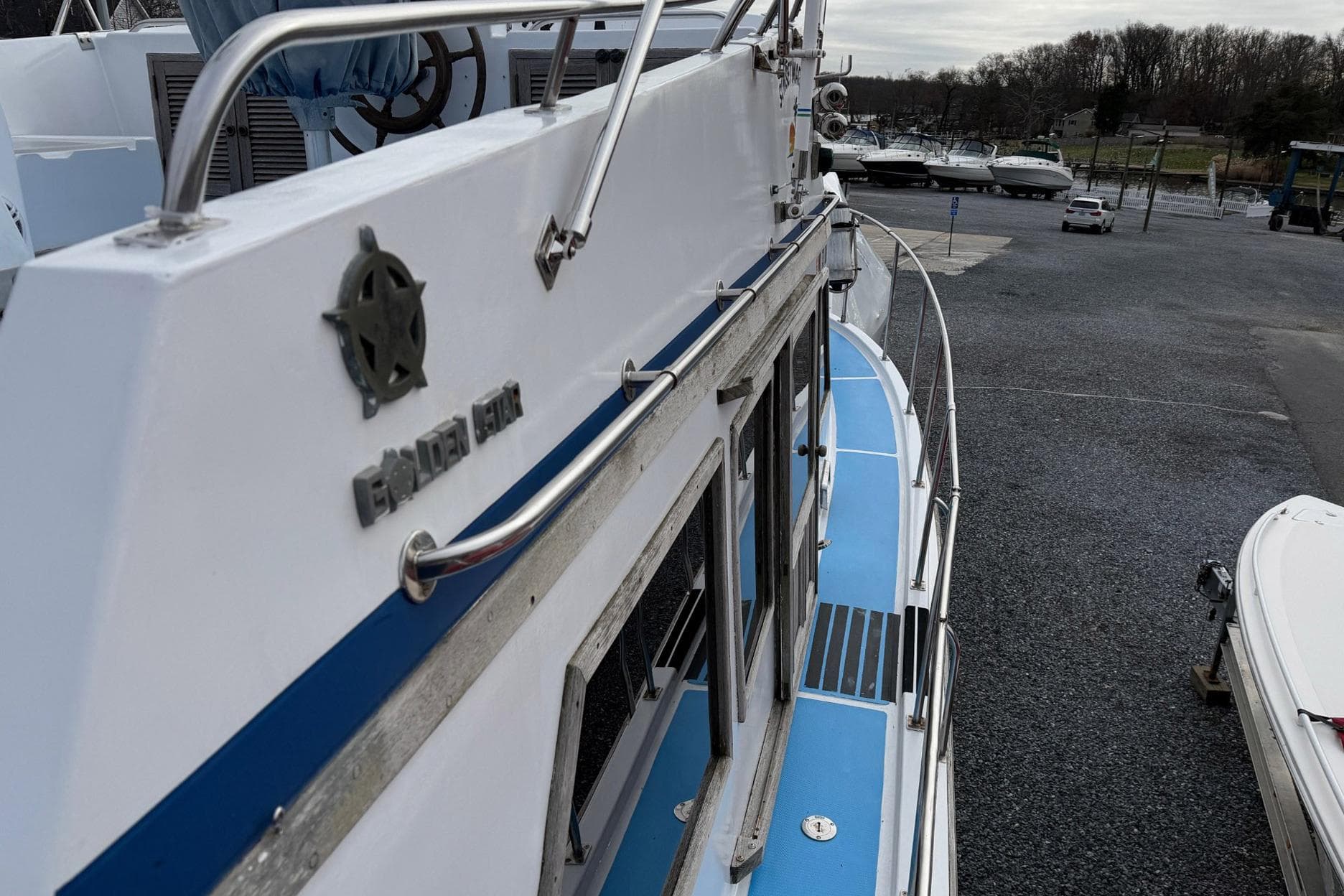 1984 Golden Star 38 Trawler docked, showcasing sleek design and blue deck accents.