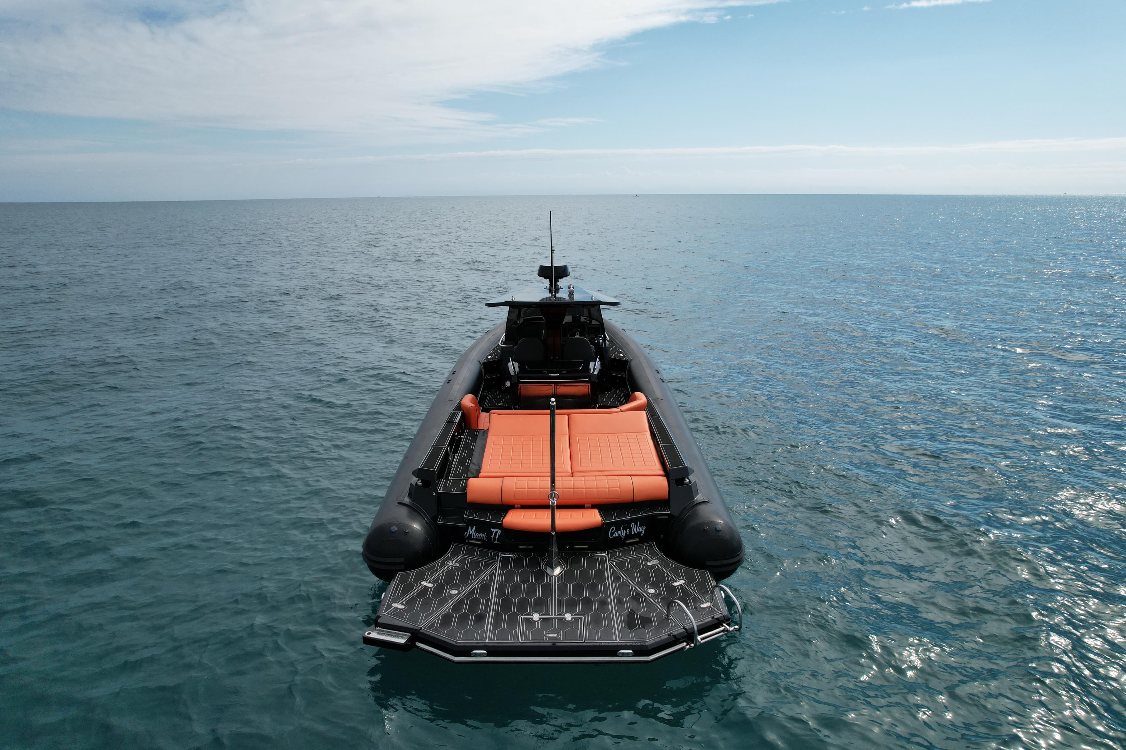 MV Marine 40 boat, 2017 model, with orange seating, floating on calm ocean waters.
