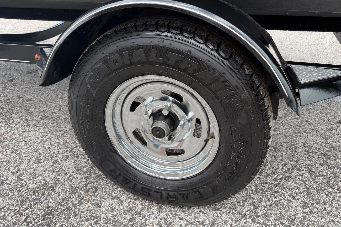 Trailer tire of a 2016 Tracker Pro Team 175 TXW on asphalt surface.