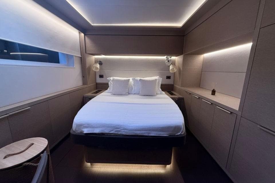 Luxurious bedroom interior of 2018 Lagoon SEVENTY 7 yacht with modern lighting and elegant design.