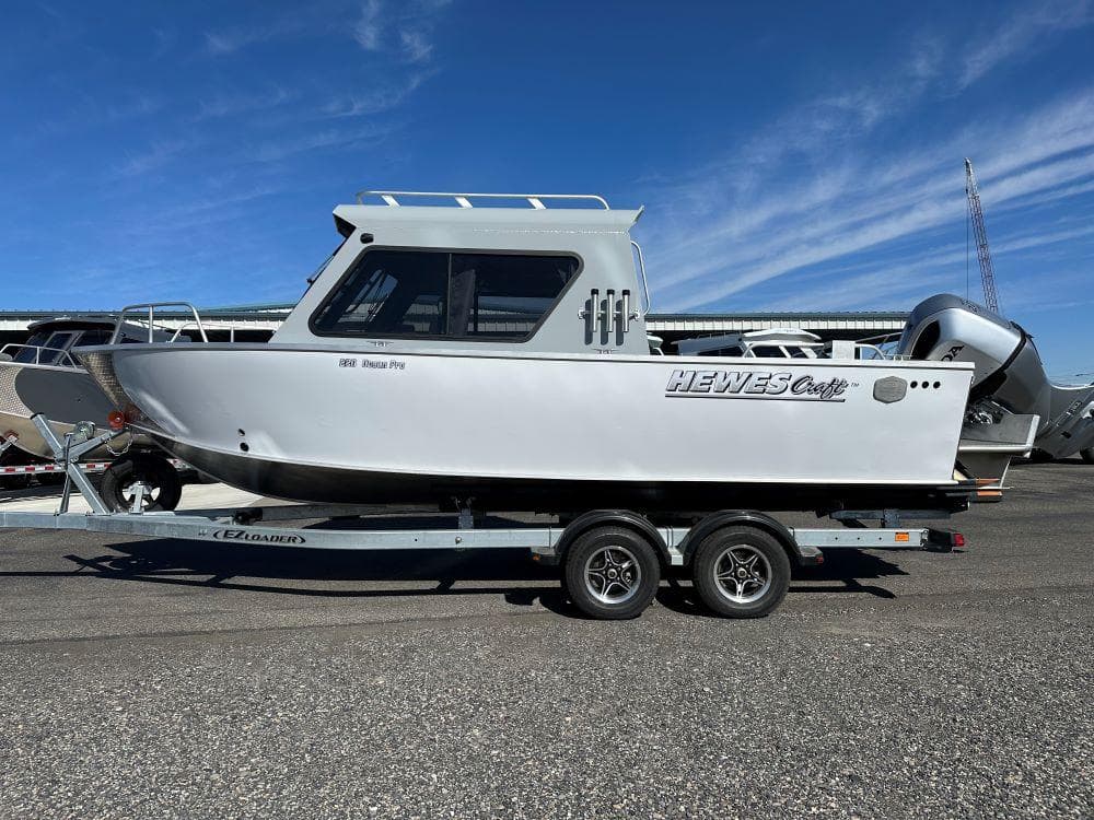 2024 Hewescraft 220 Ocean Pro HT ET boat on a trailer under a clear blue sky.