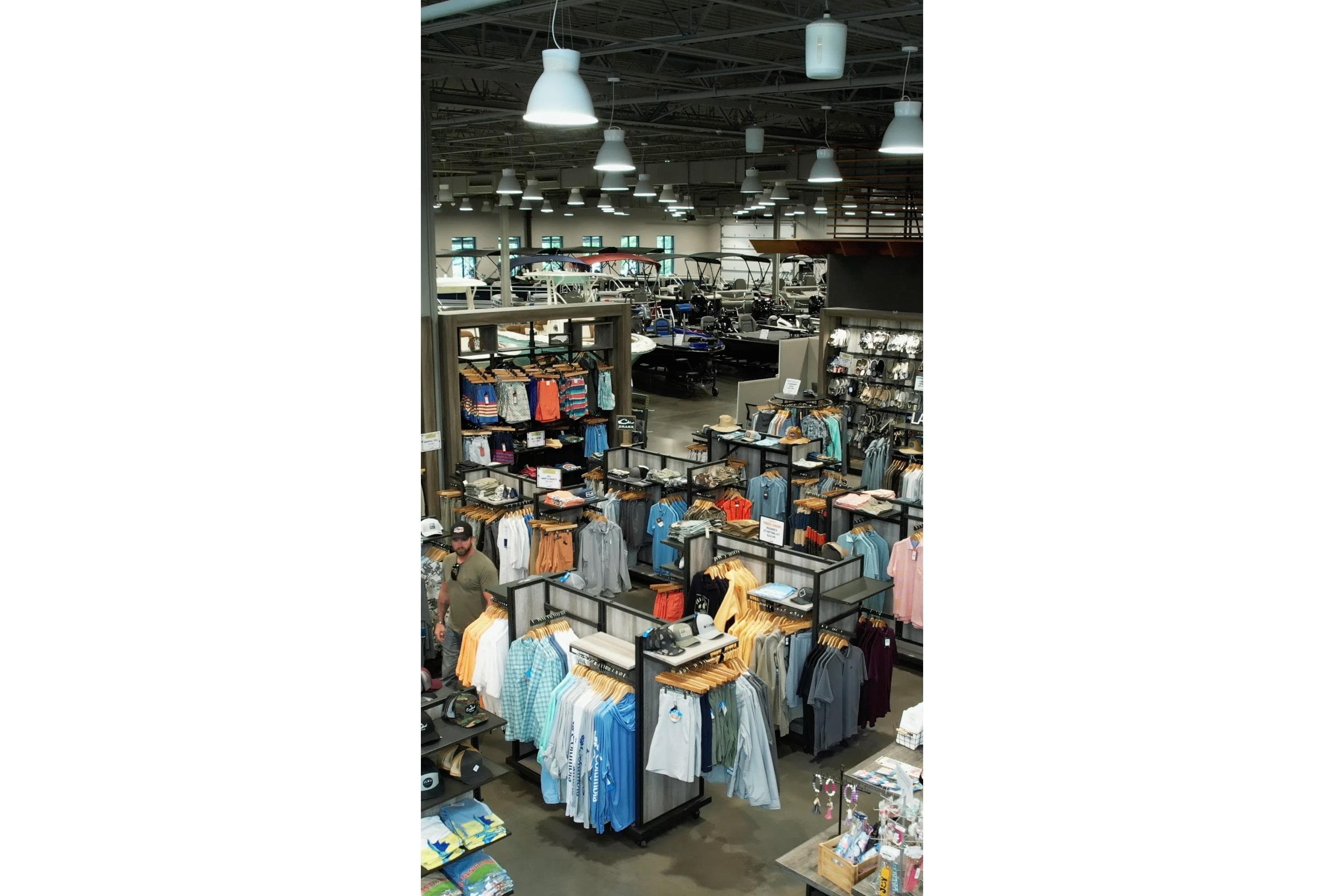 Clothing store interior with 2026 Barletta Lusso 23UCA boat in background.