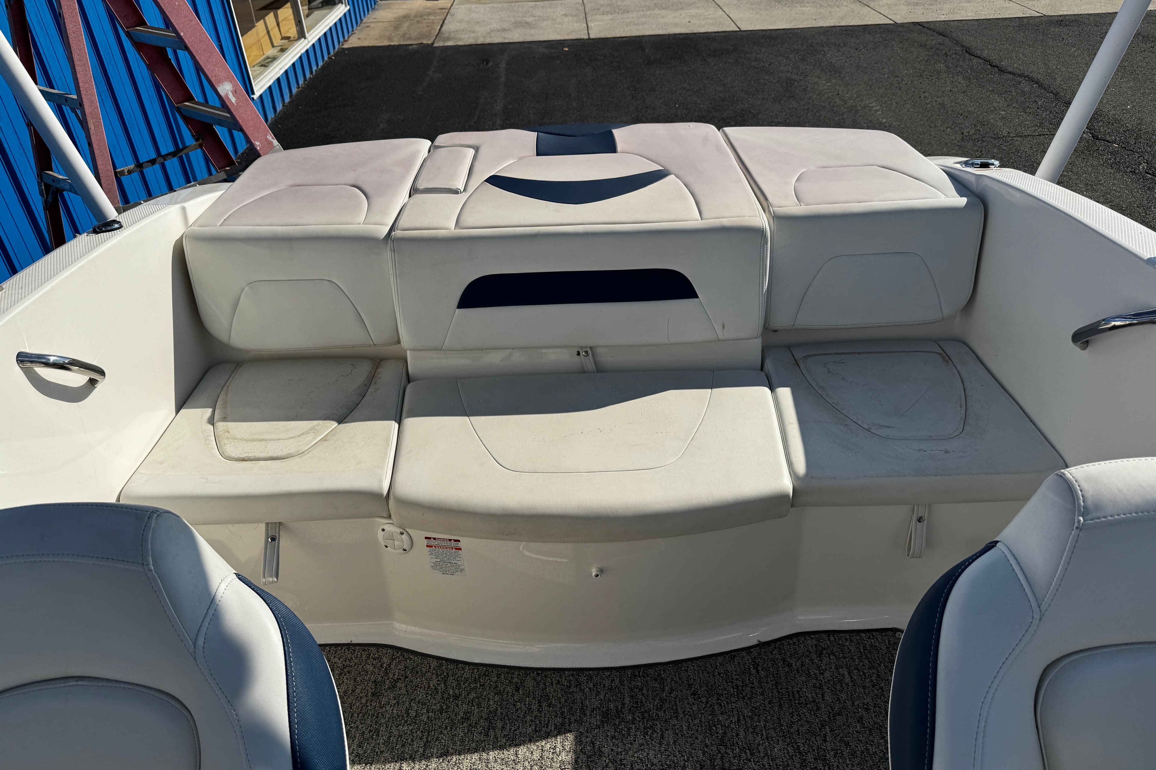 2015 Chaparral 19 H2O Sport boat interior with white seating and storage compartments.
