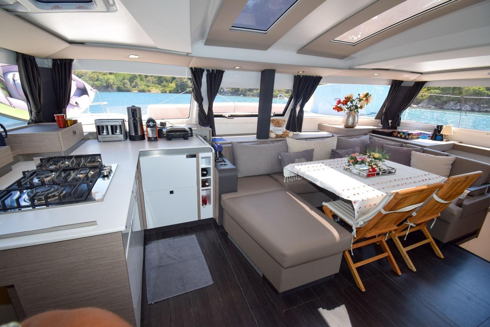 Luxurious interior of 2020 Fountaine Pajot Elba 45 catamaran with modern kitchen and dining area.