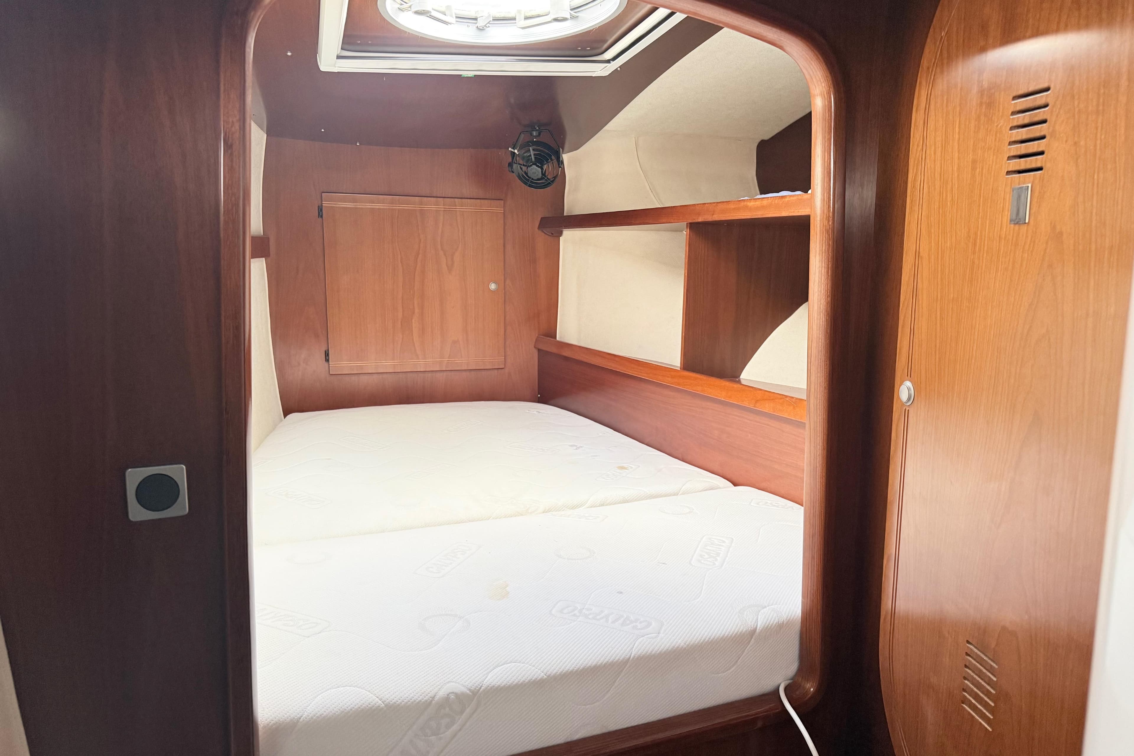Cozy cabin interior of 2003 Fountaine Pajot Belize 43 catamaran with wooden finish.