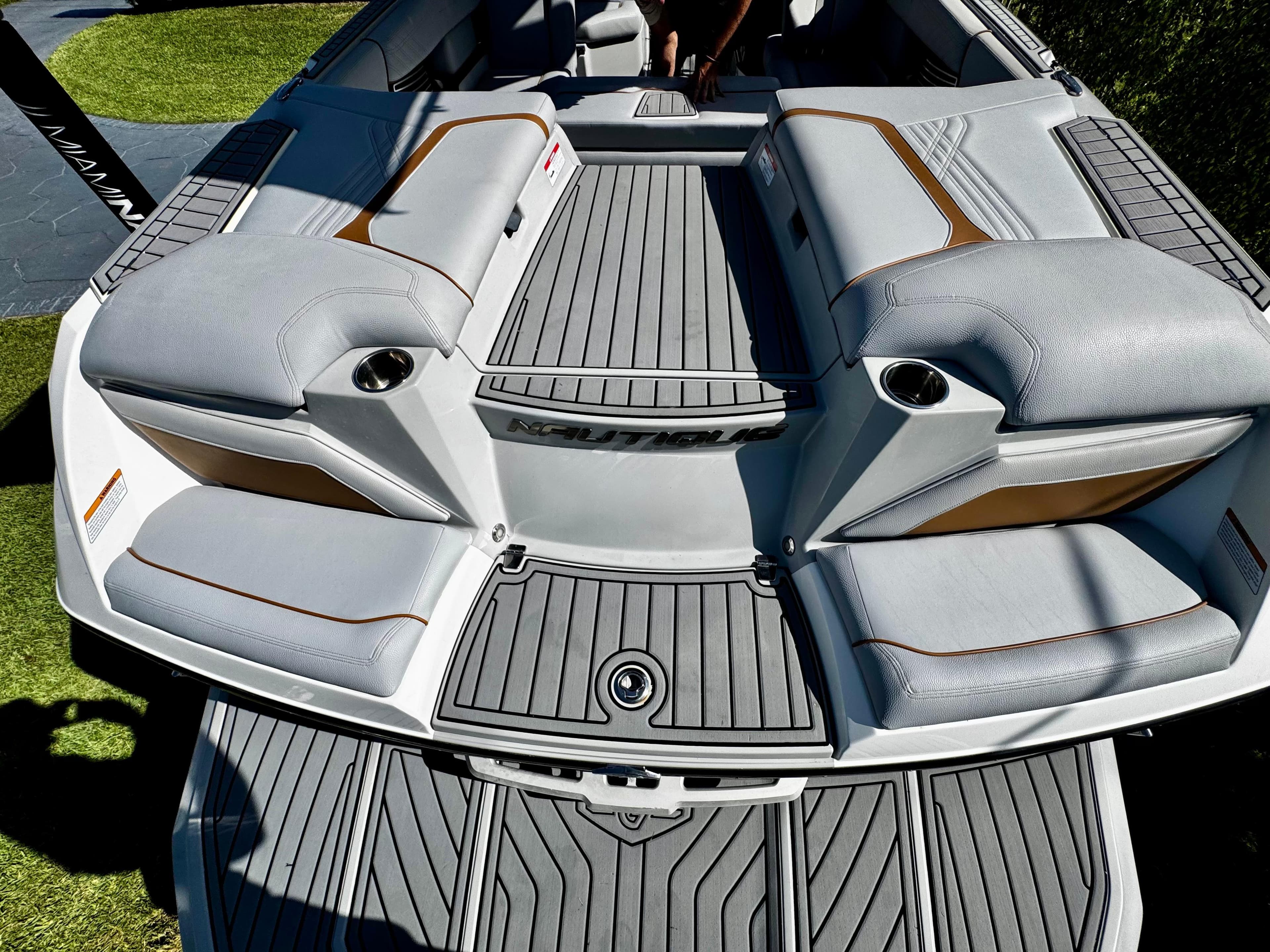 2020 Nautique Super Air Nautique G25 Coastal Edition boat interior with gray seating and cup holders.