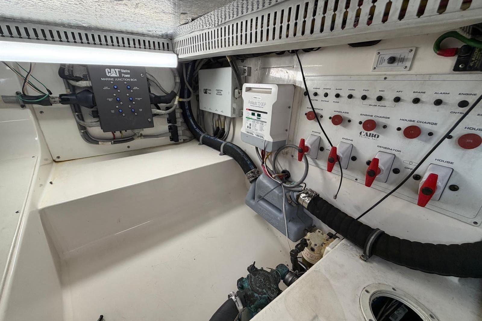 Engine room of 2004 Cabo 35 Flybridge with control panels and wiring.