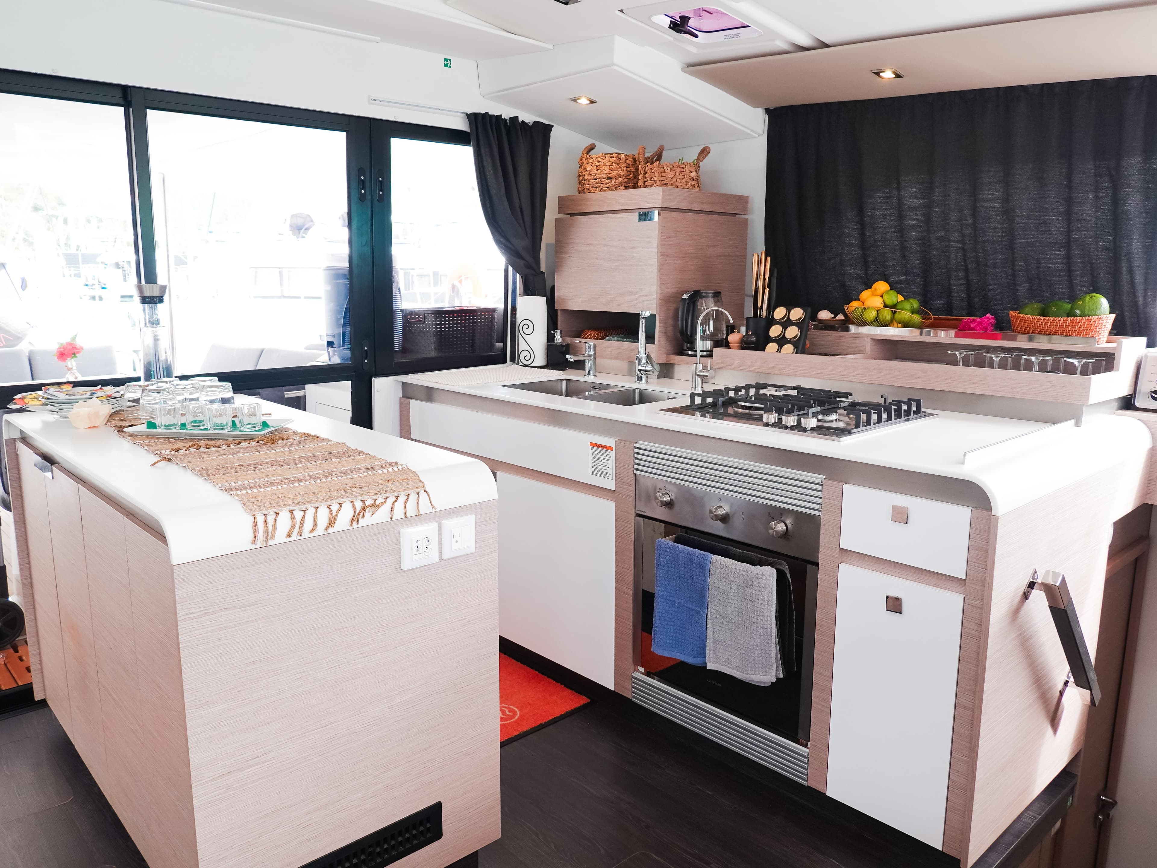 Modern kitchen interior of 2022 Fountaine Pajot Catamaran Aura 51 with sleek design and amenities.