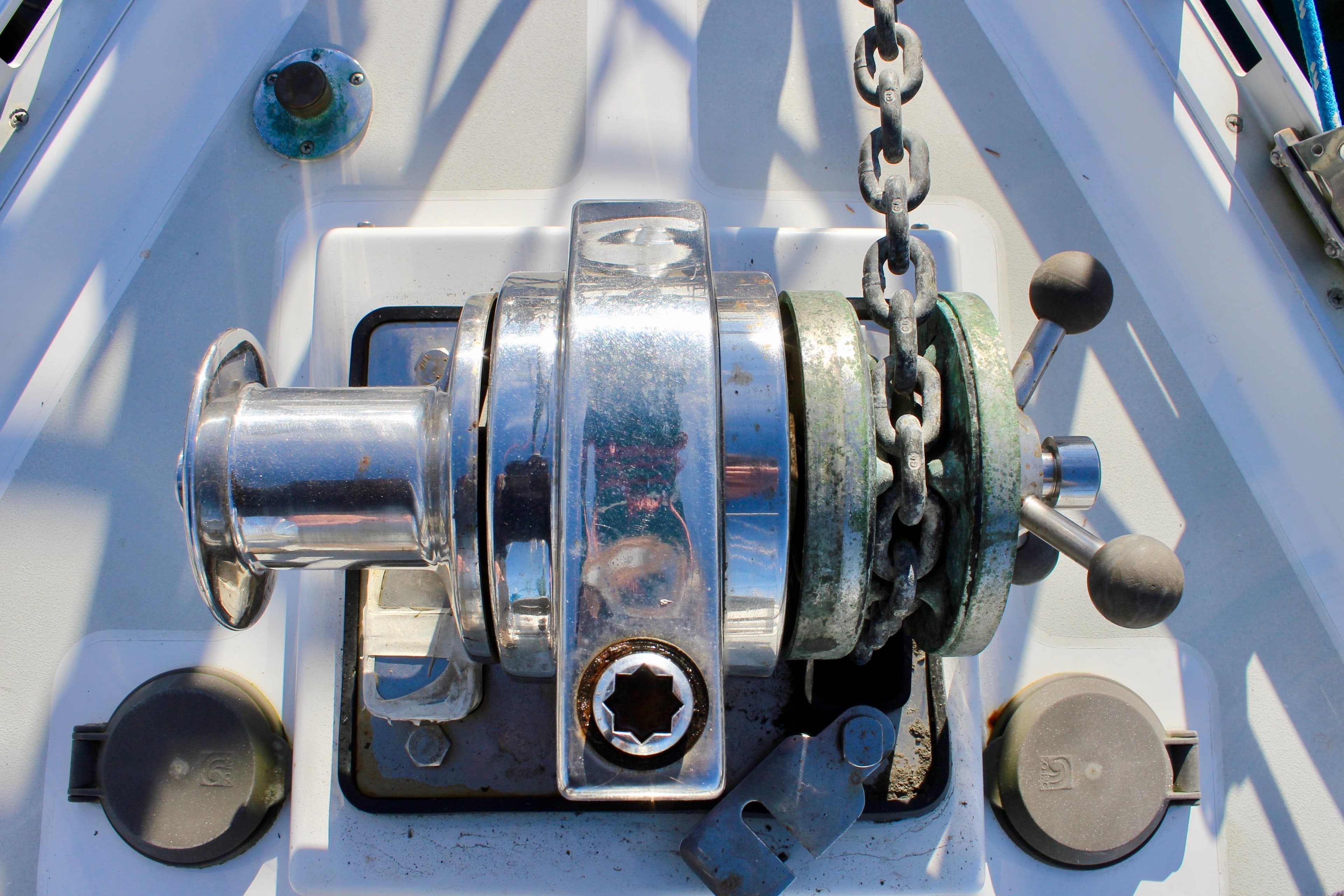 Anchor windlass on a 1997 Valiant 39 sailboat deck, featuring chain and controls.