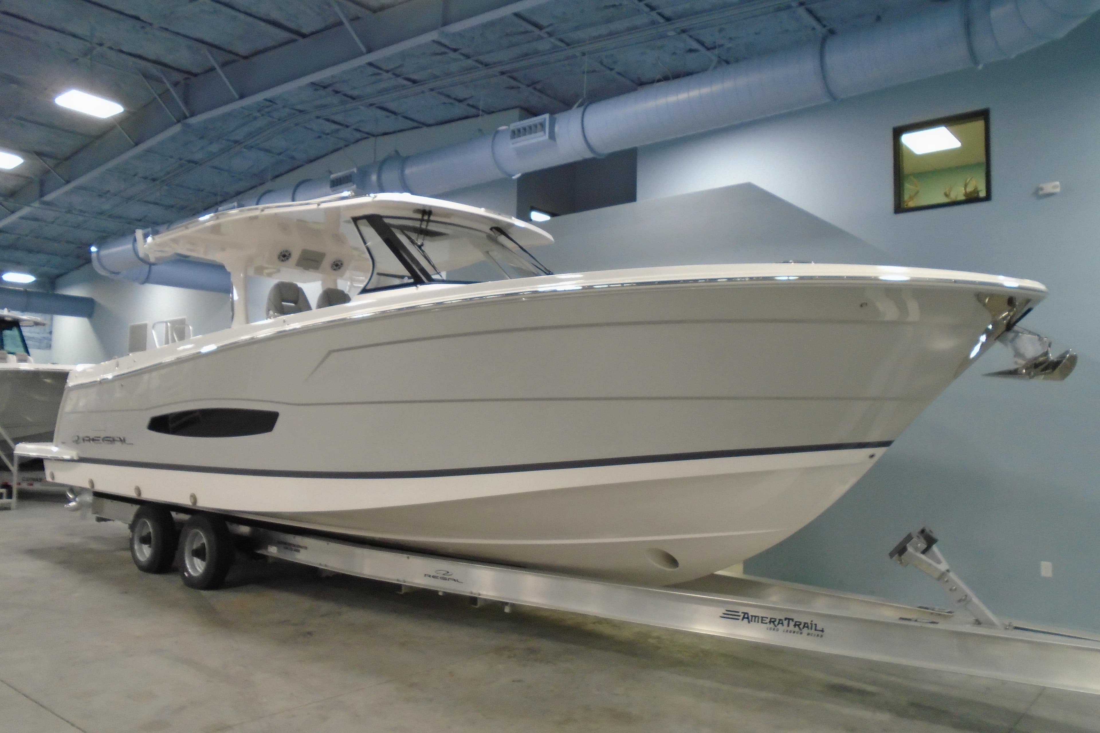 2026 Regal 38 SAV boat on trailer in indoor showroom setting.