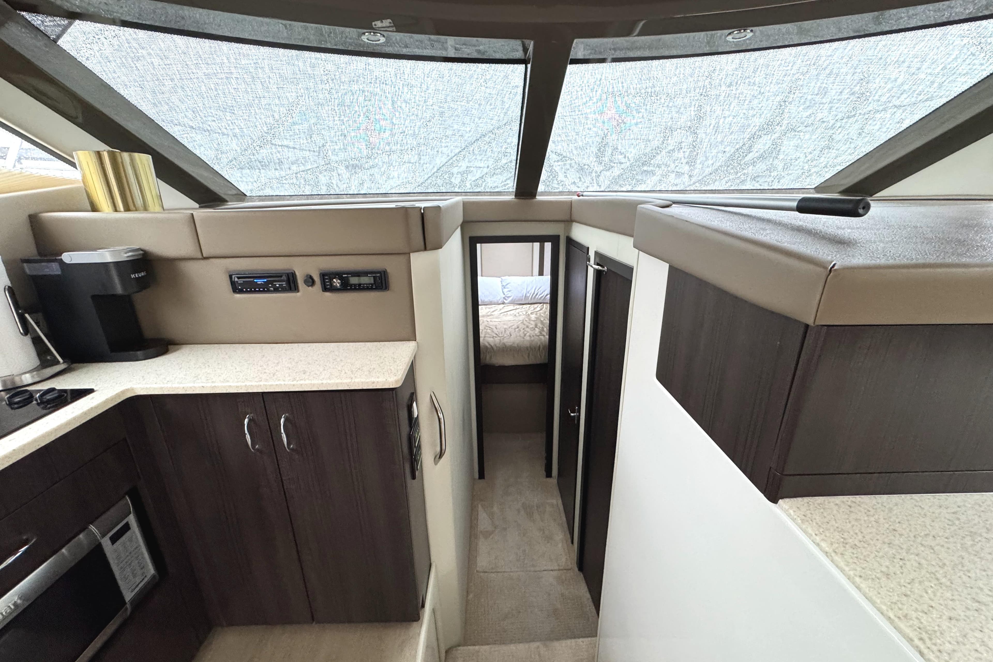 Interior of 2014 Carver C40 Command Bridge yacht with modern kitchen and cozy cabin.