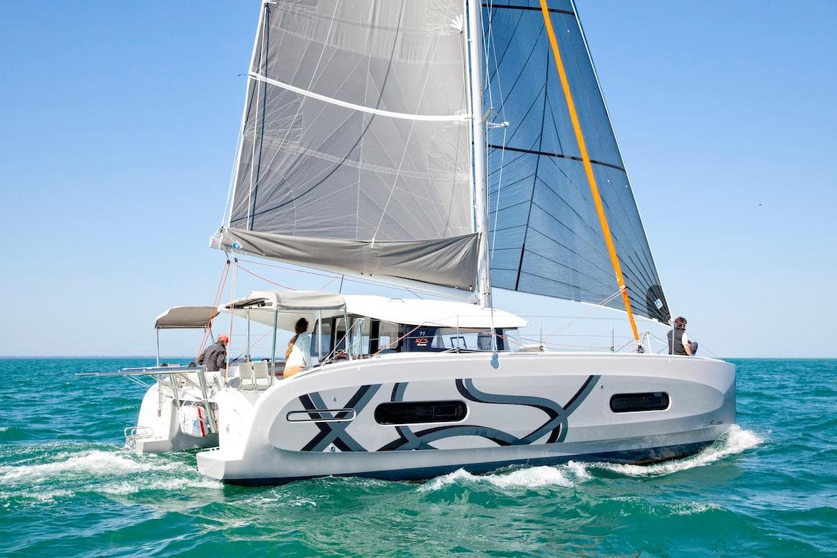 Sailing catamaran Excess 11, 2026 model, cruising on clear blue ocean waters.