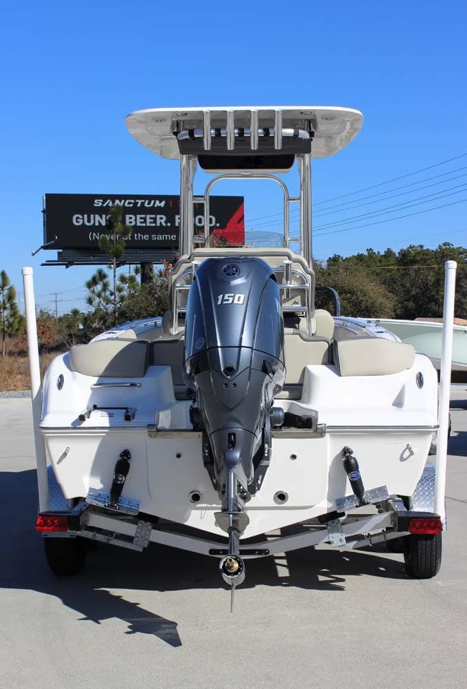 2025 Key West 203 FS boat with powerful outboard motor, parked outdoors.