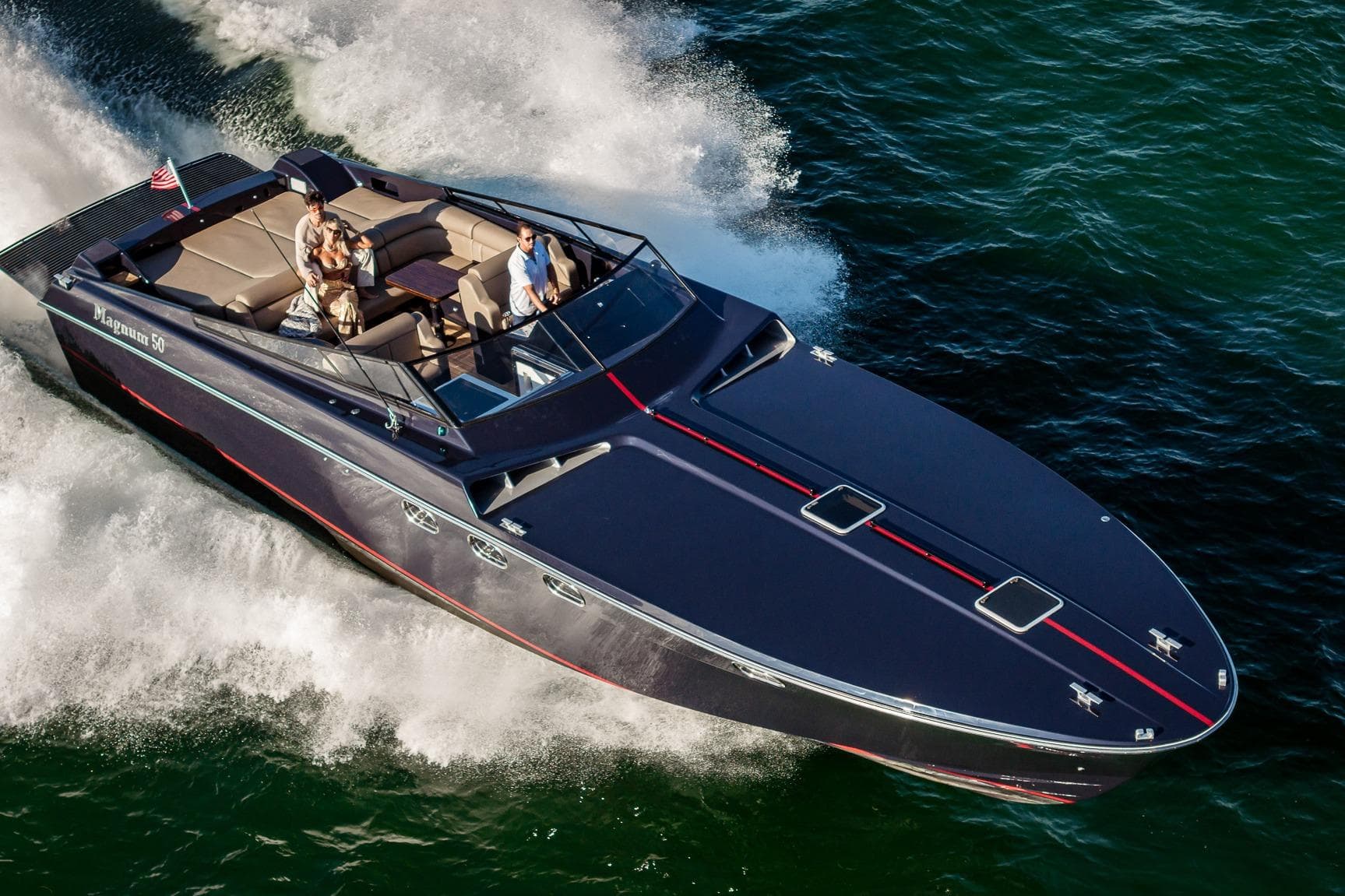 Luxury Magnum 50 Bestia yacht cruising on water, 2000 model, with passengers enjoying the ride.