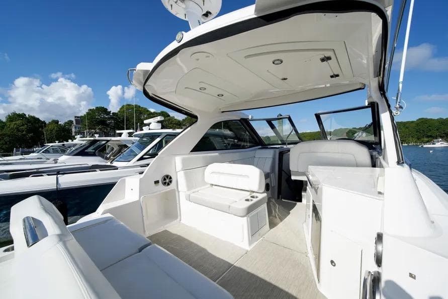 2019 Regal 35 Sport Coupe yacht interior with seating, docked under clear blue sky.