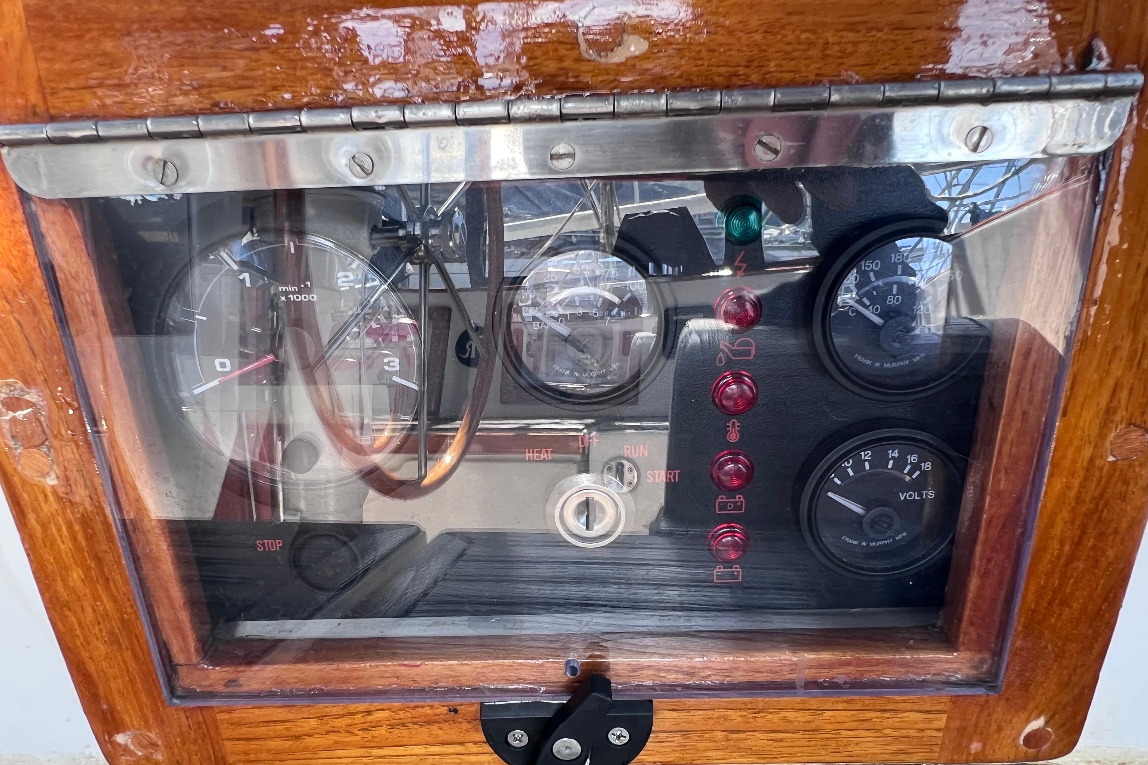 Control panel of a 1990 Cabo Rico 38R sailboat with gauges and indicators.