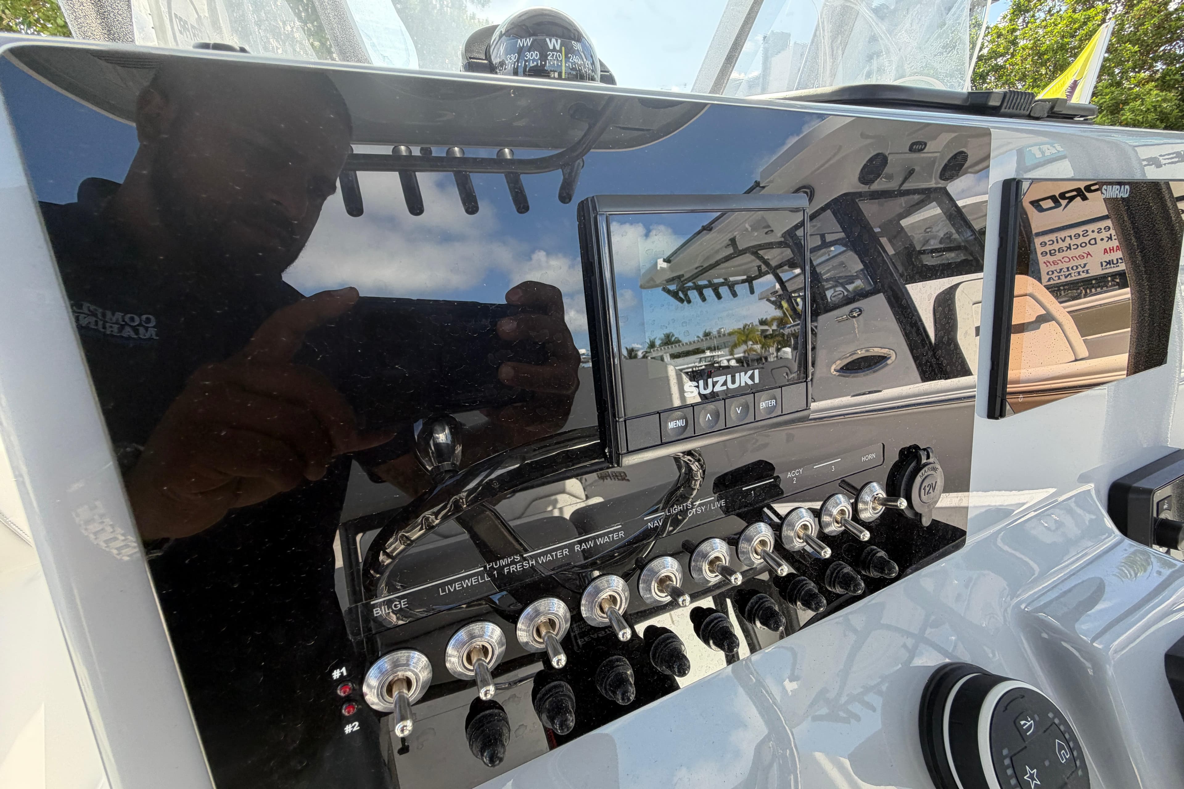 2026 Sea Pro 225FLX Sandbar boat dashboard with Suzuki controls and switches.