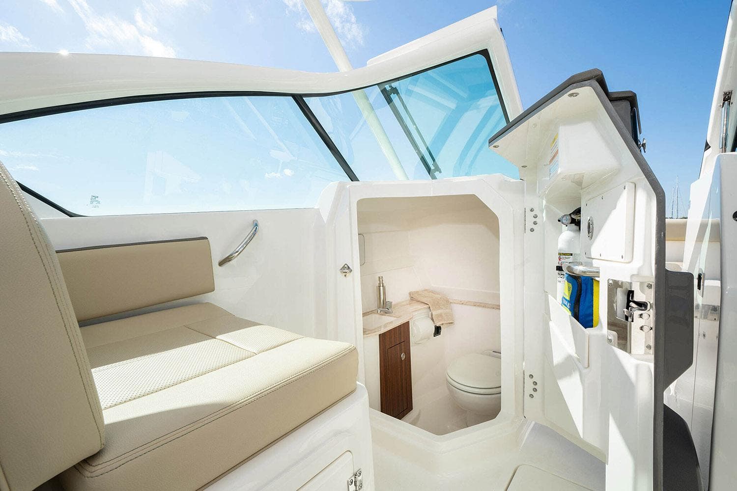 Manufacturer Provided Image: 2025 Pursuit DC 266 Dual Console boat interior with seating and compact bathroom.