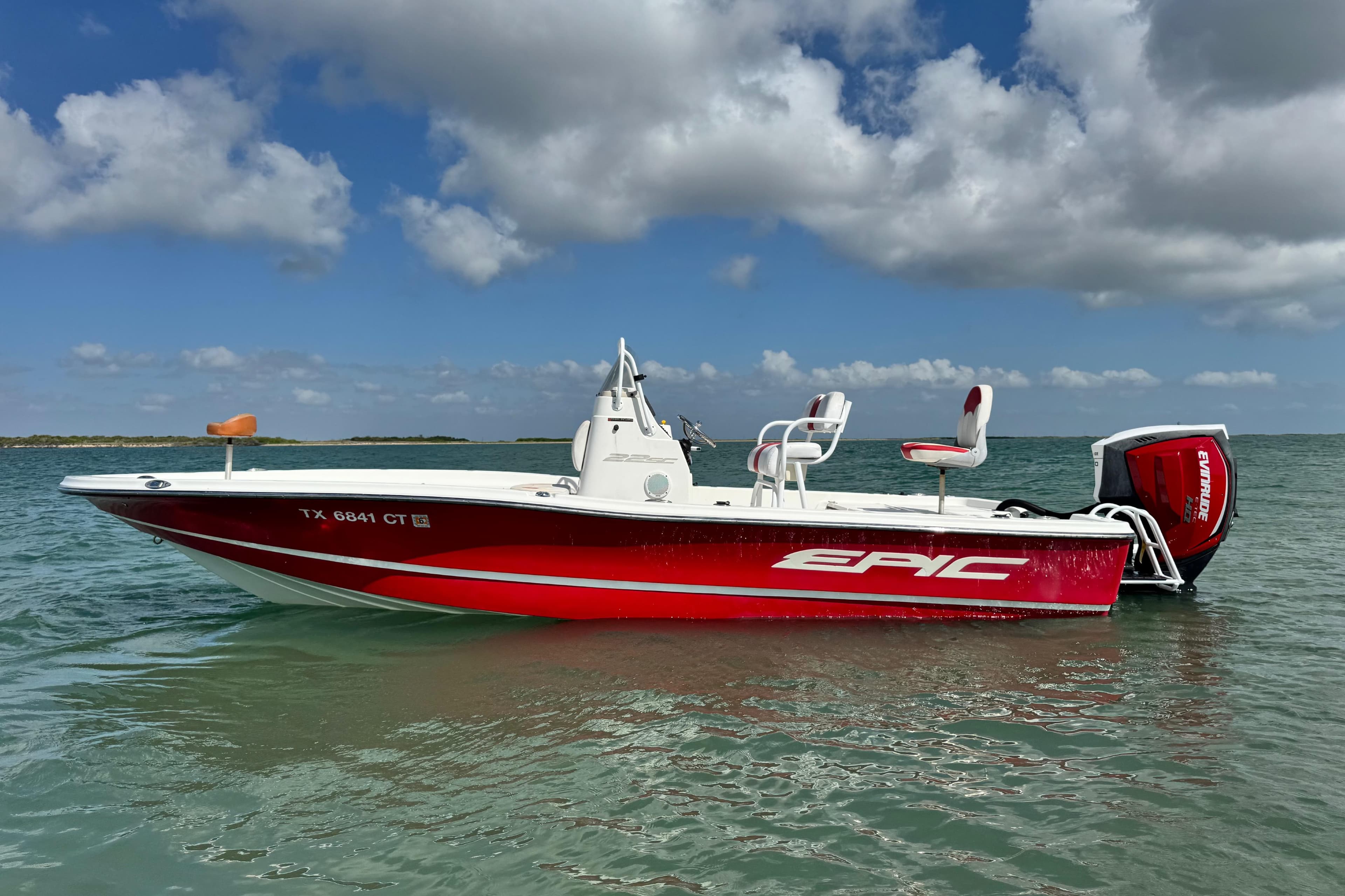 2015 Epic 22 Sport Console boat on water under blue sky.