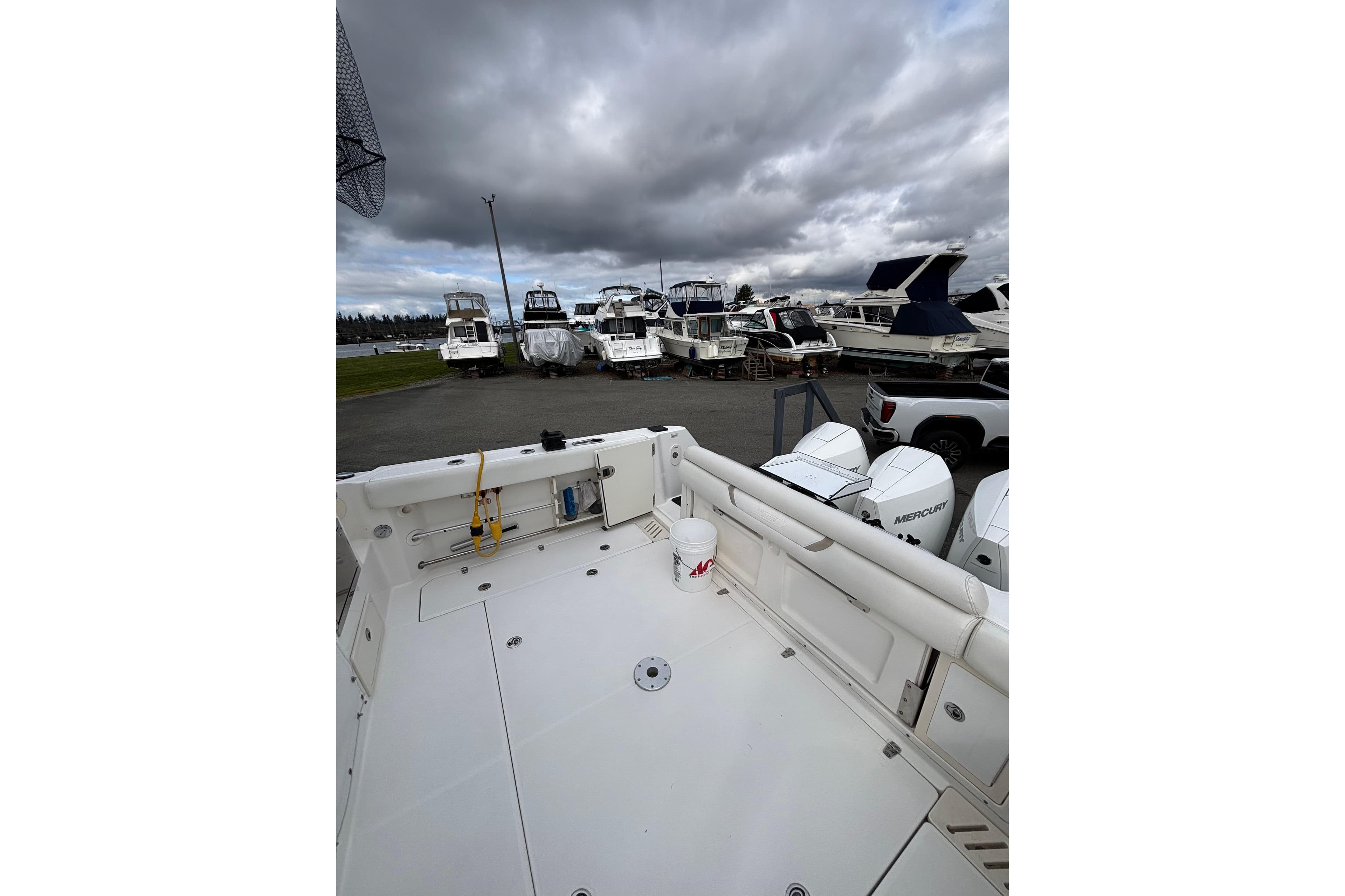 2010 Boston Whaler 345 Conquest boat docked with cloudy sky background.