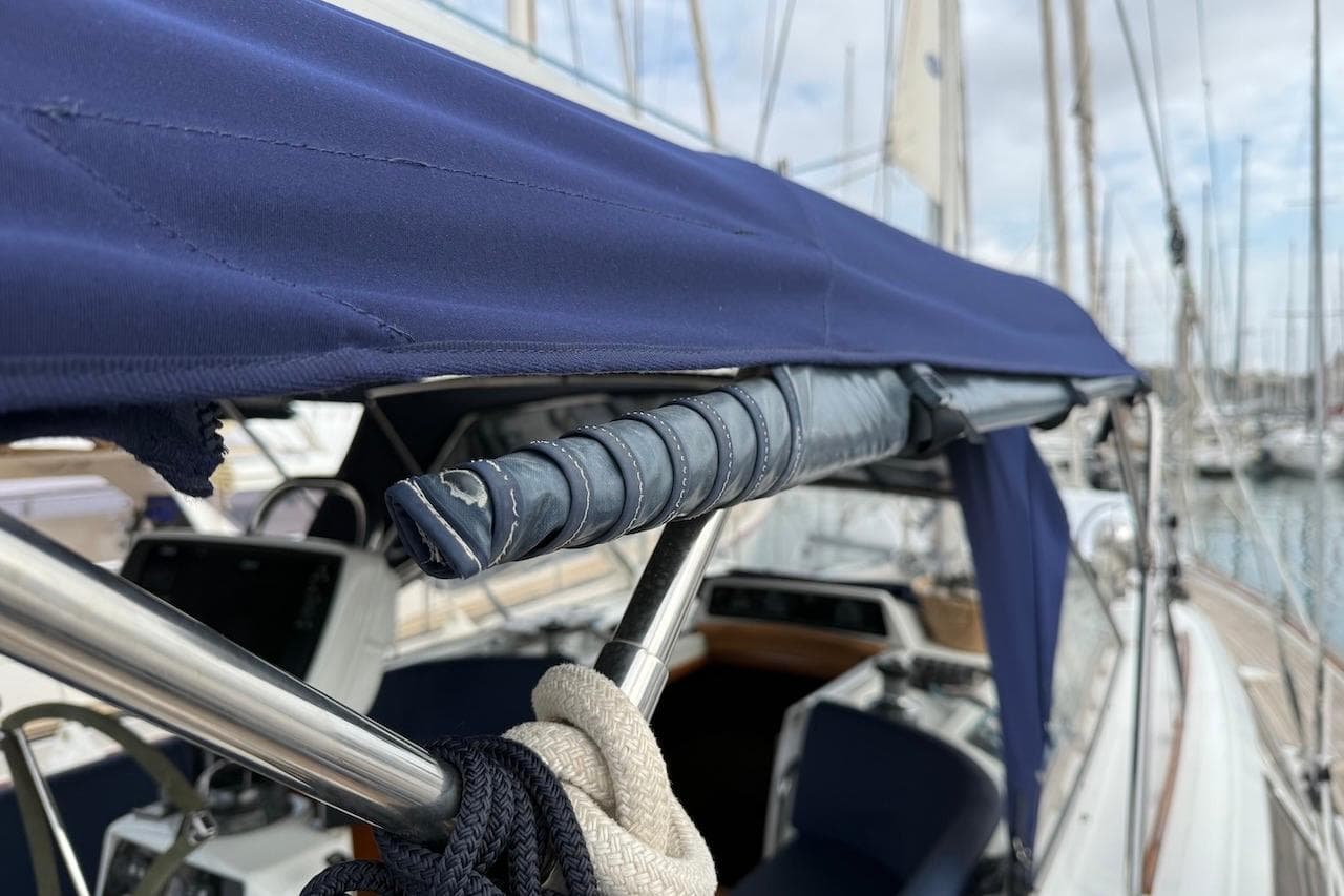 Sailboat cockpit with blue canopy, Moody 47, 2002 model, docked at marina.