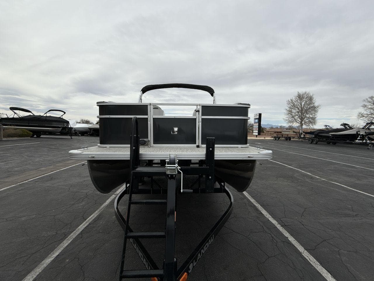 2025 Landau Island Breeze 19 C pontoon boat on trailer in parking lot.