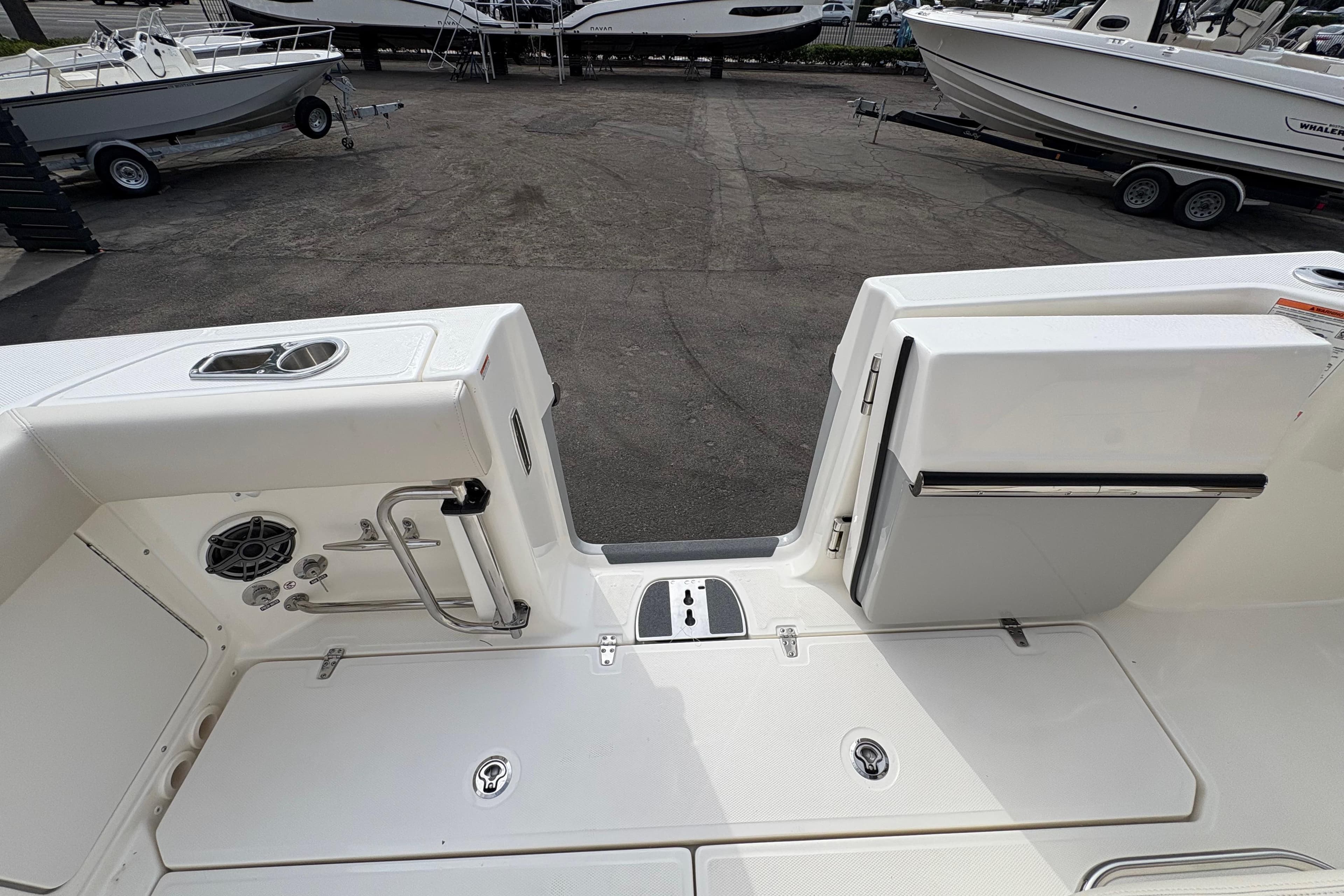 2026 Boston Whaler 330 Outrage boat deck with storage and seating area.