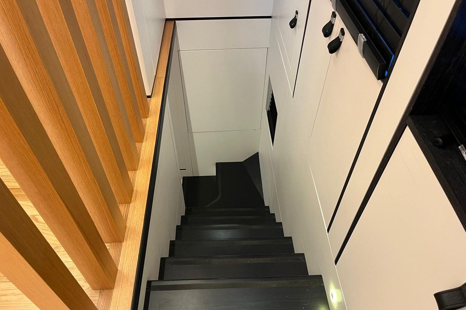 Modern interior staircase in 2024 Explorer ICE, featuring sleek design and wooden accents.