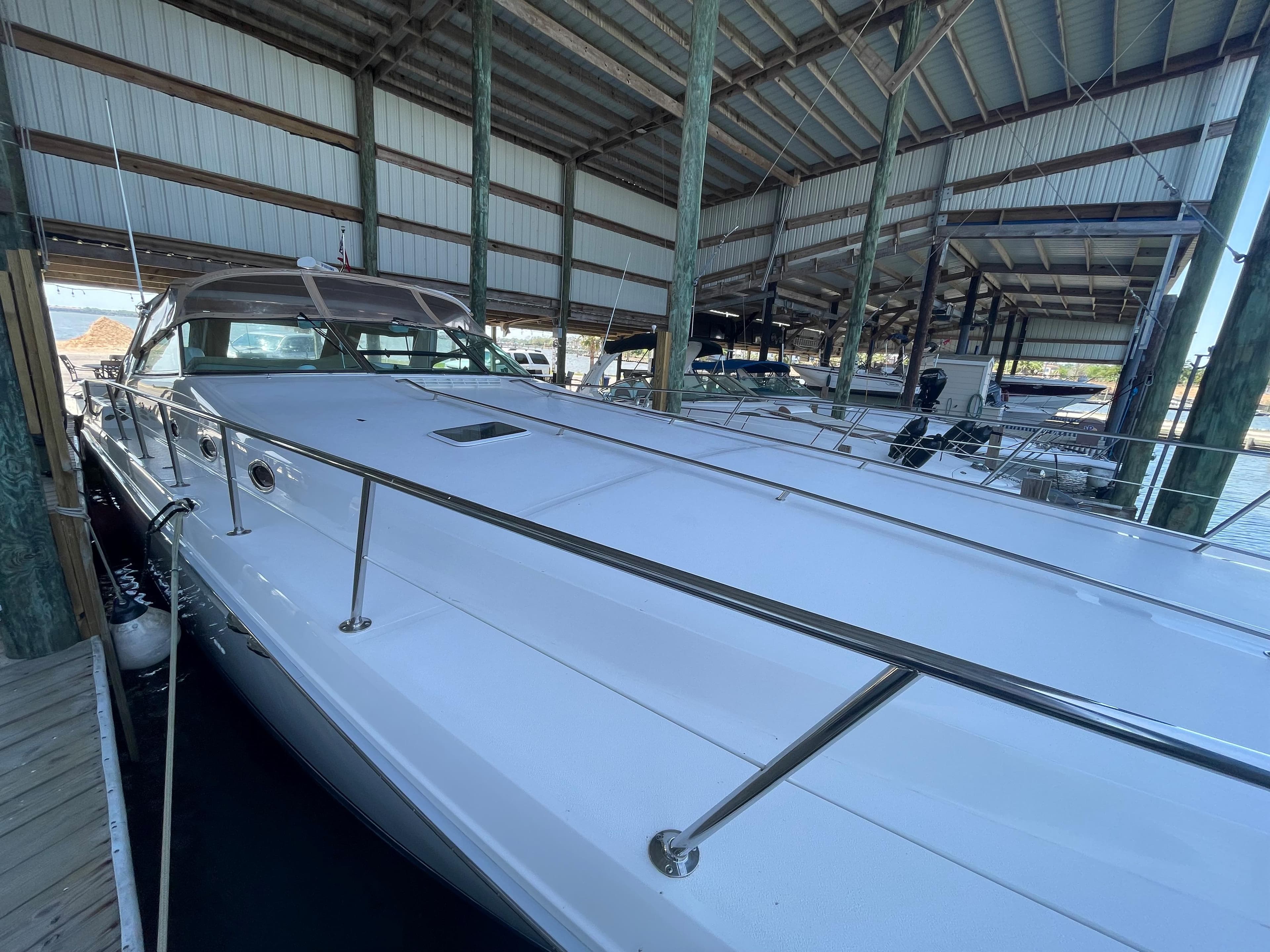 1996 Sea Ray 500 Sundancer yacht docked in a covered marina.
