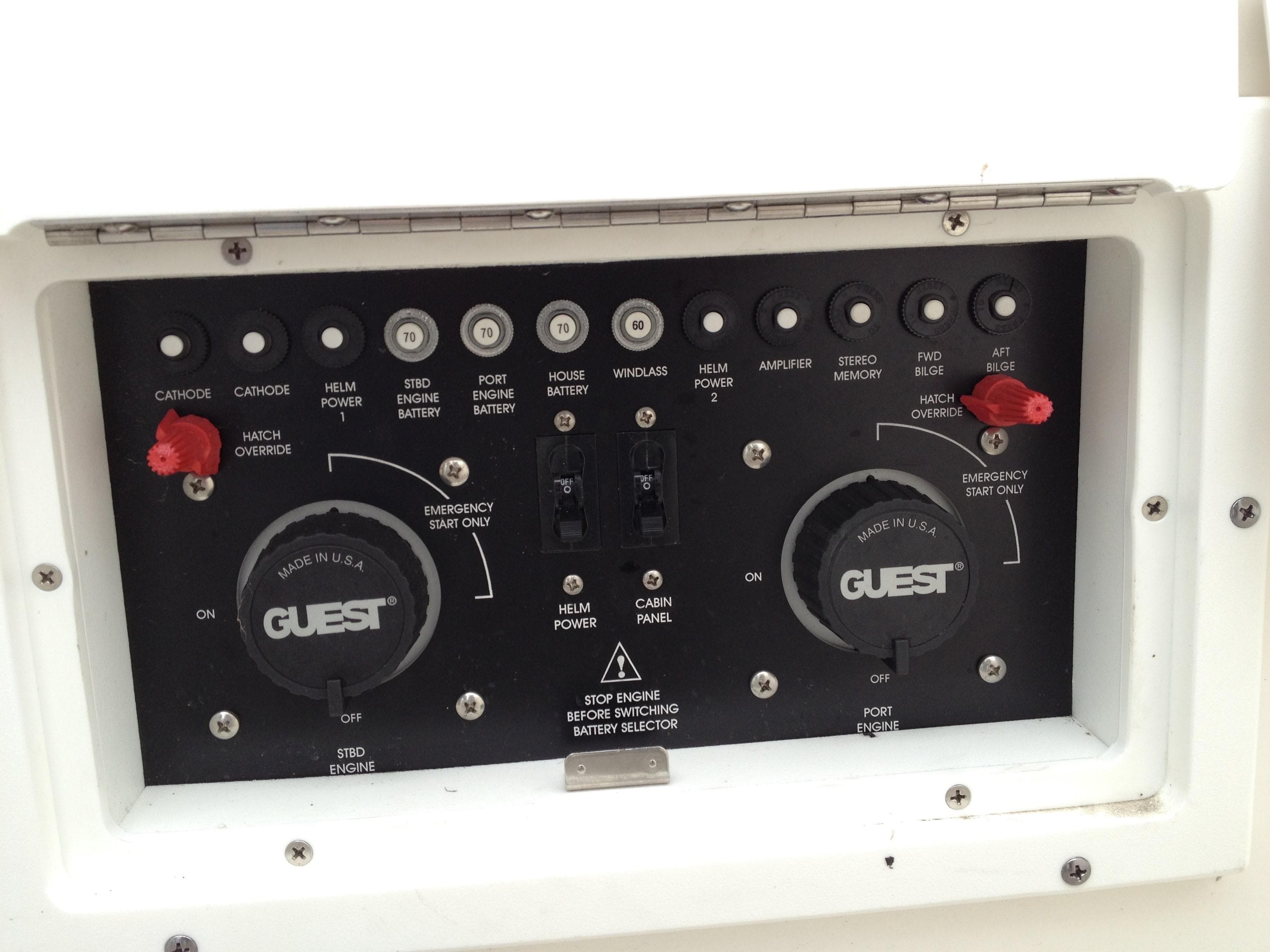 Control panel of a 2006 Rinker 320 Express Cruiser with various switches and dials.
