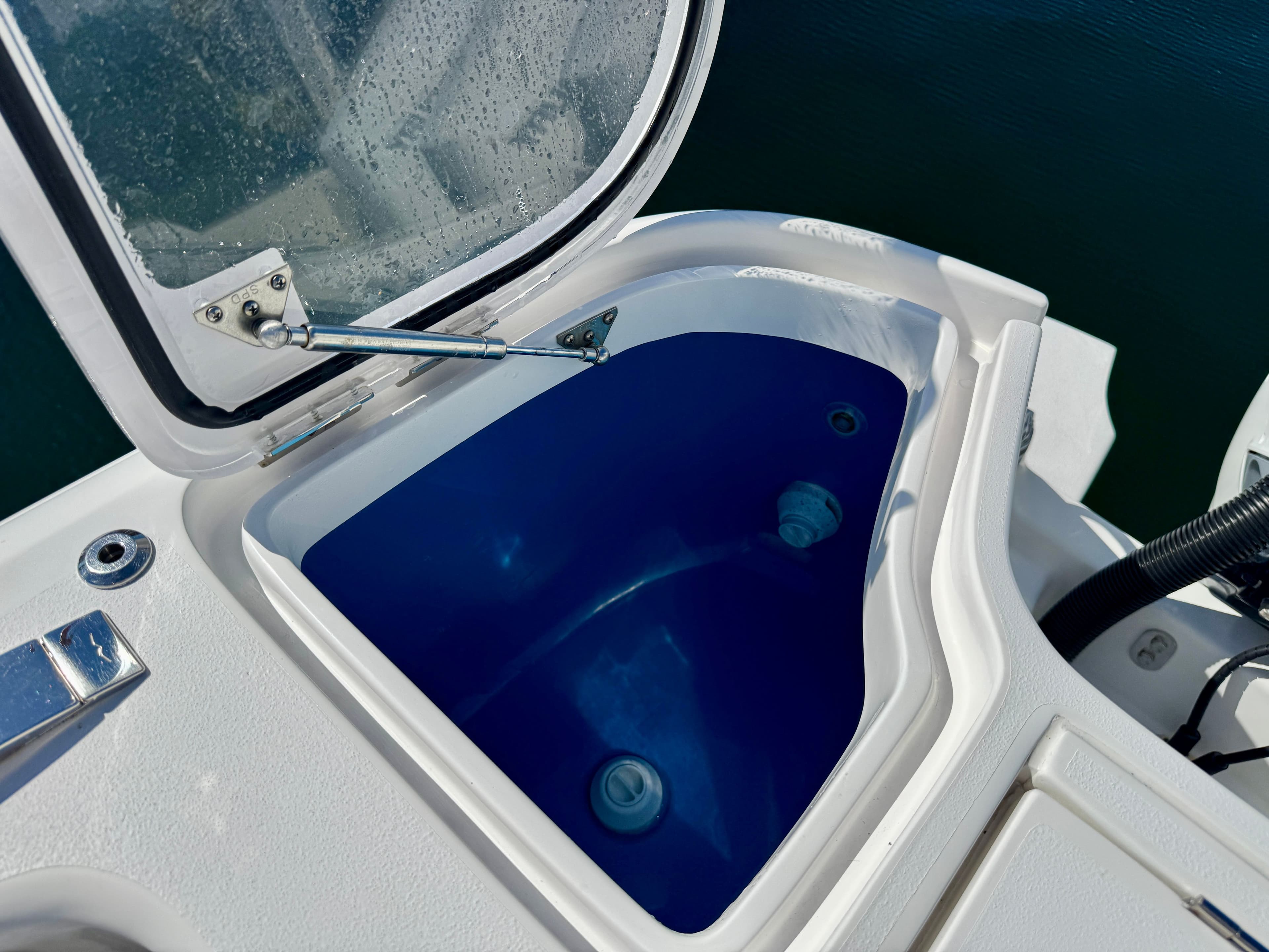 2024 Intrepid 407 Nomad FE boat with open storage compartment.