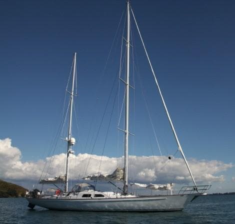Sailing yacht Dubois 78, 1993 model, anchored under clear blue sky.