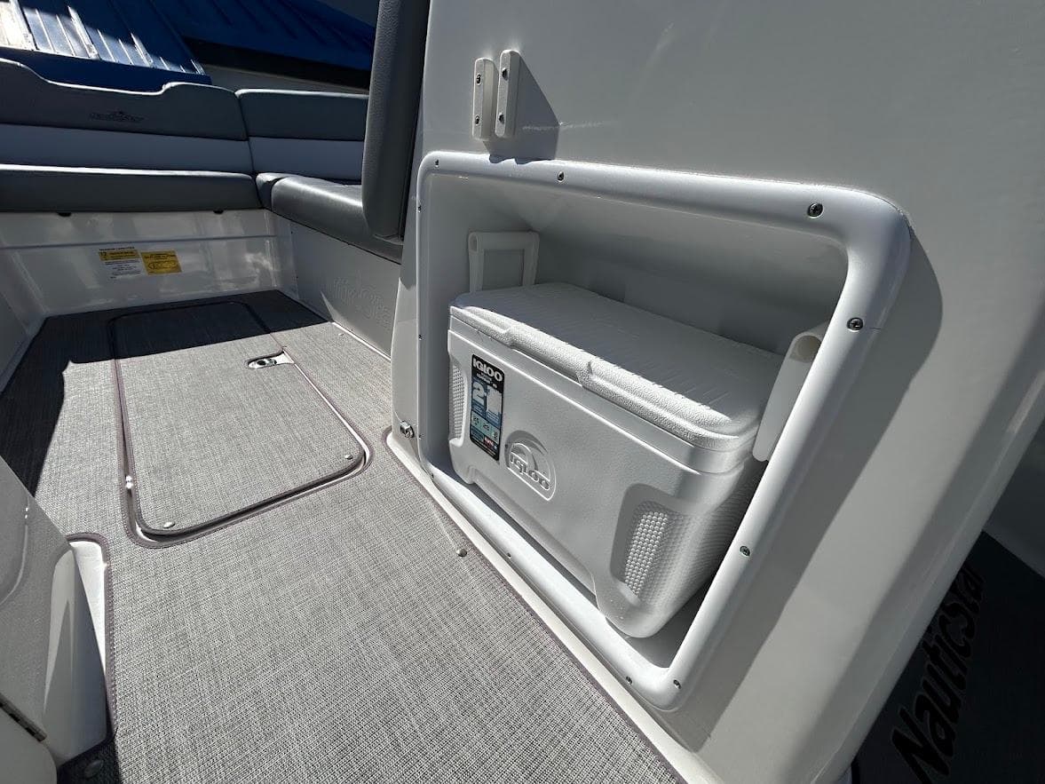 2022 NauticStar 243DC Sport Deck interior with built-in cooler and seating.