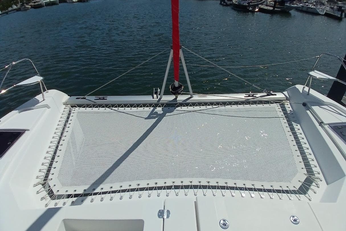 2022 Leopard 42 catamaran with netting, docked in a marina.