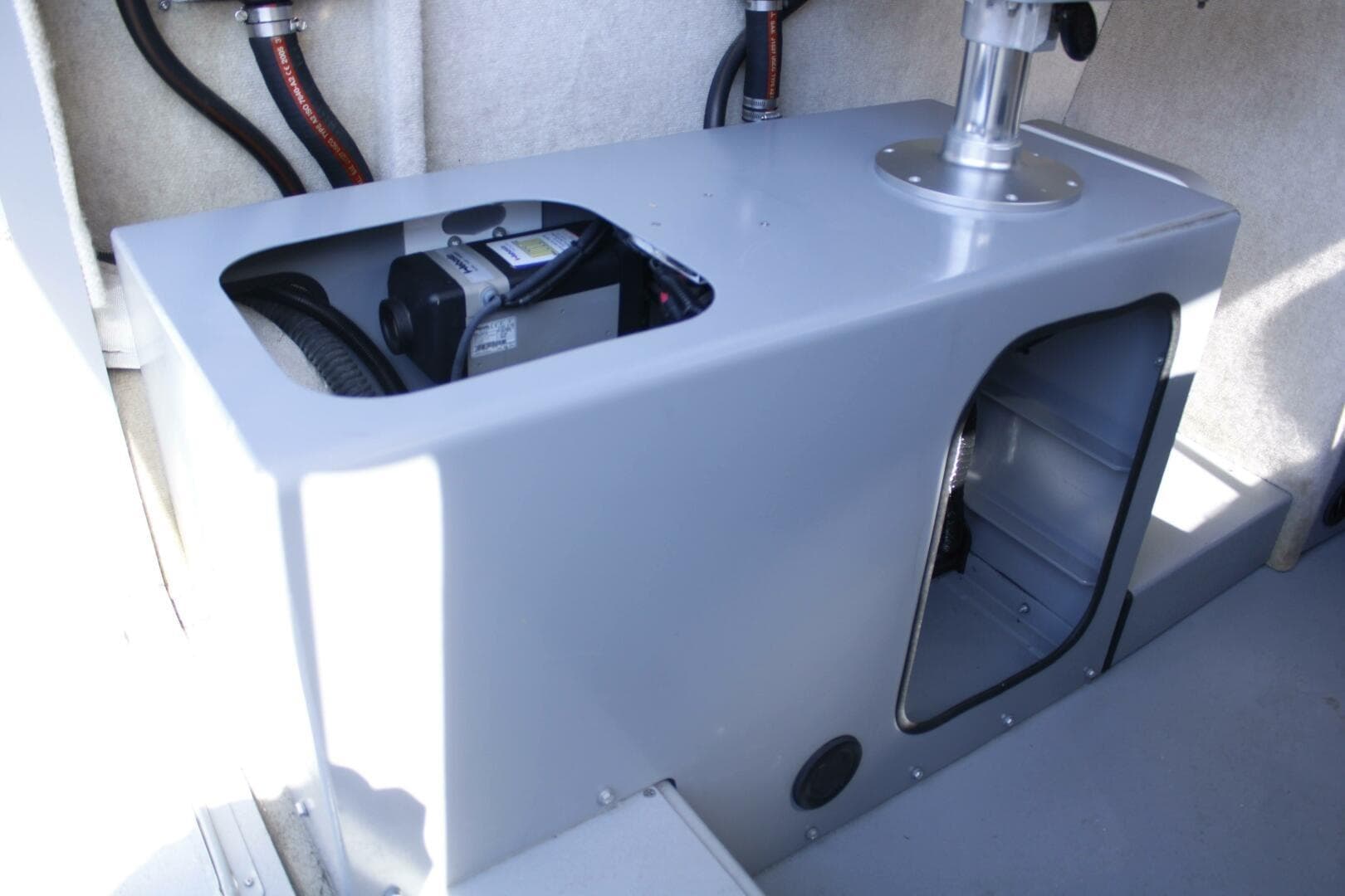 Interior view of a 2005 ACB 27 boat, showcasing storage compartment and equipment.