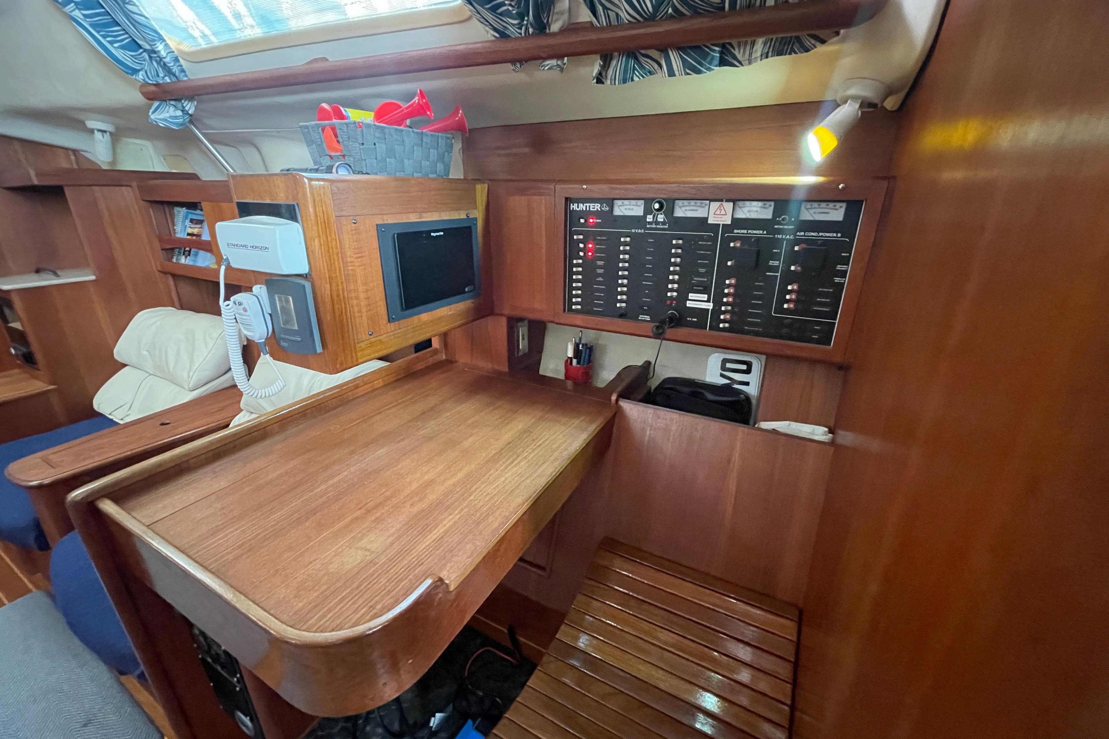 Interior of a 1999 Hunter 460 sailboat with navigation station and control panel.