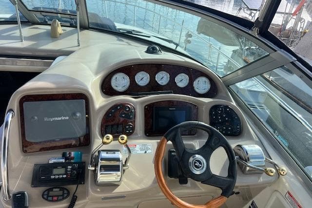 2005 Searay 320 boat dashboard with steering wheel and navigation instruments.
